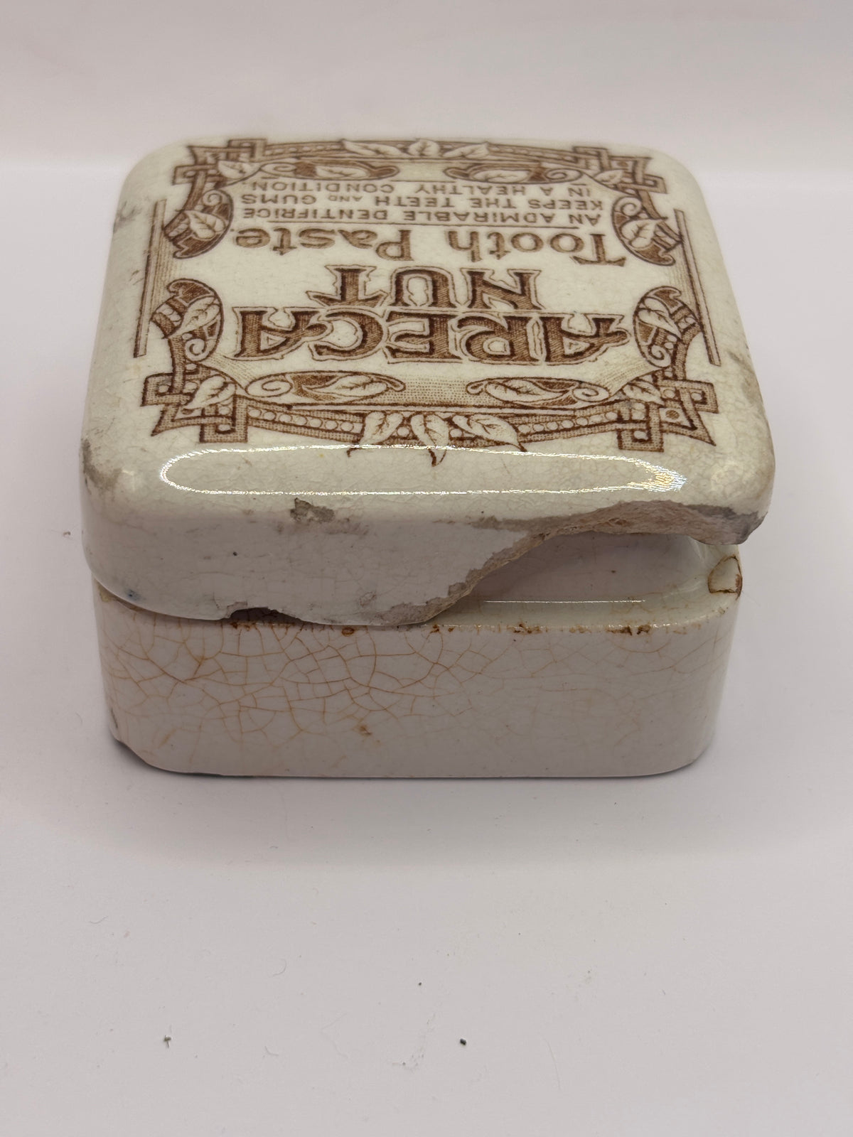 Old advertising lid and base. Areca nut toothpaste. Serpia print. Damaged