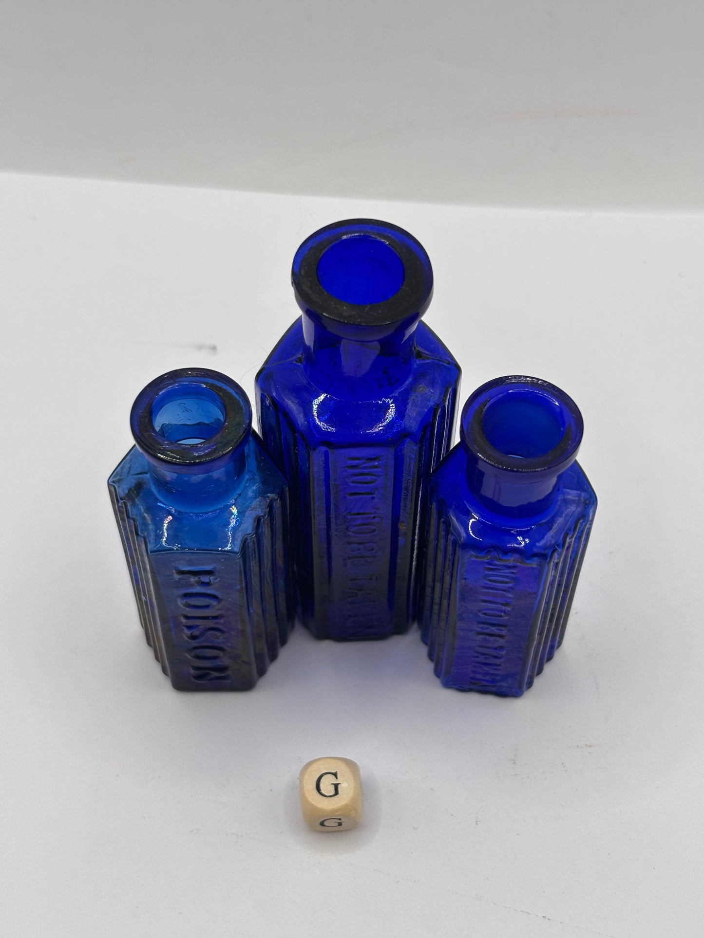 3 old blue glass poison bottles