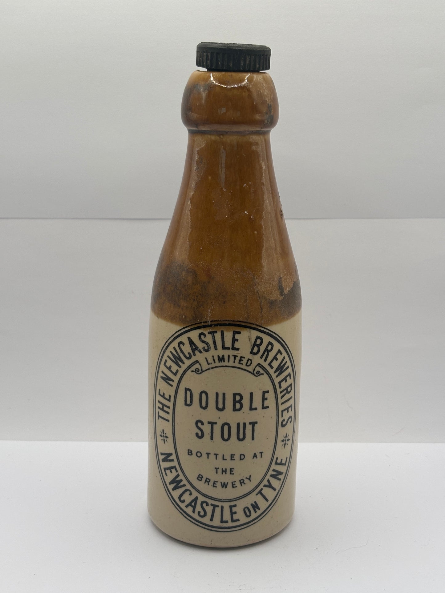 Old stoneware stout bottle, The newcastle breweries double stout. Newcastle on tyne
