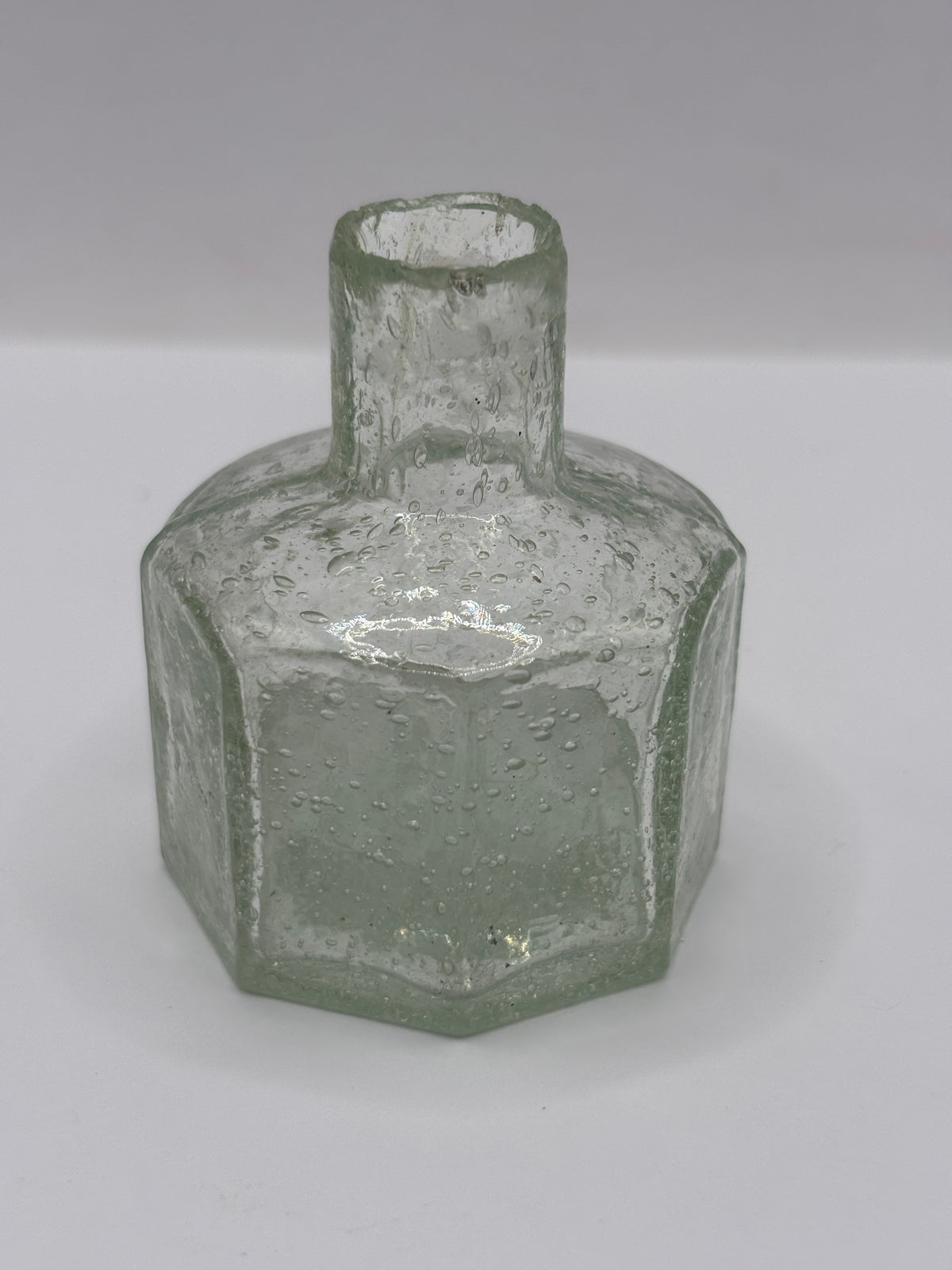 Old glass inkwell, bubbly ink