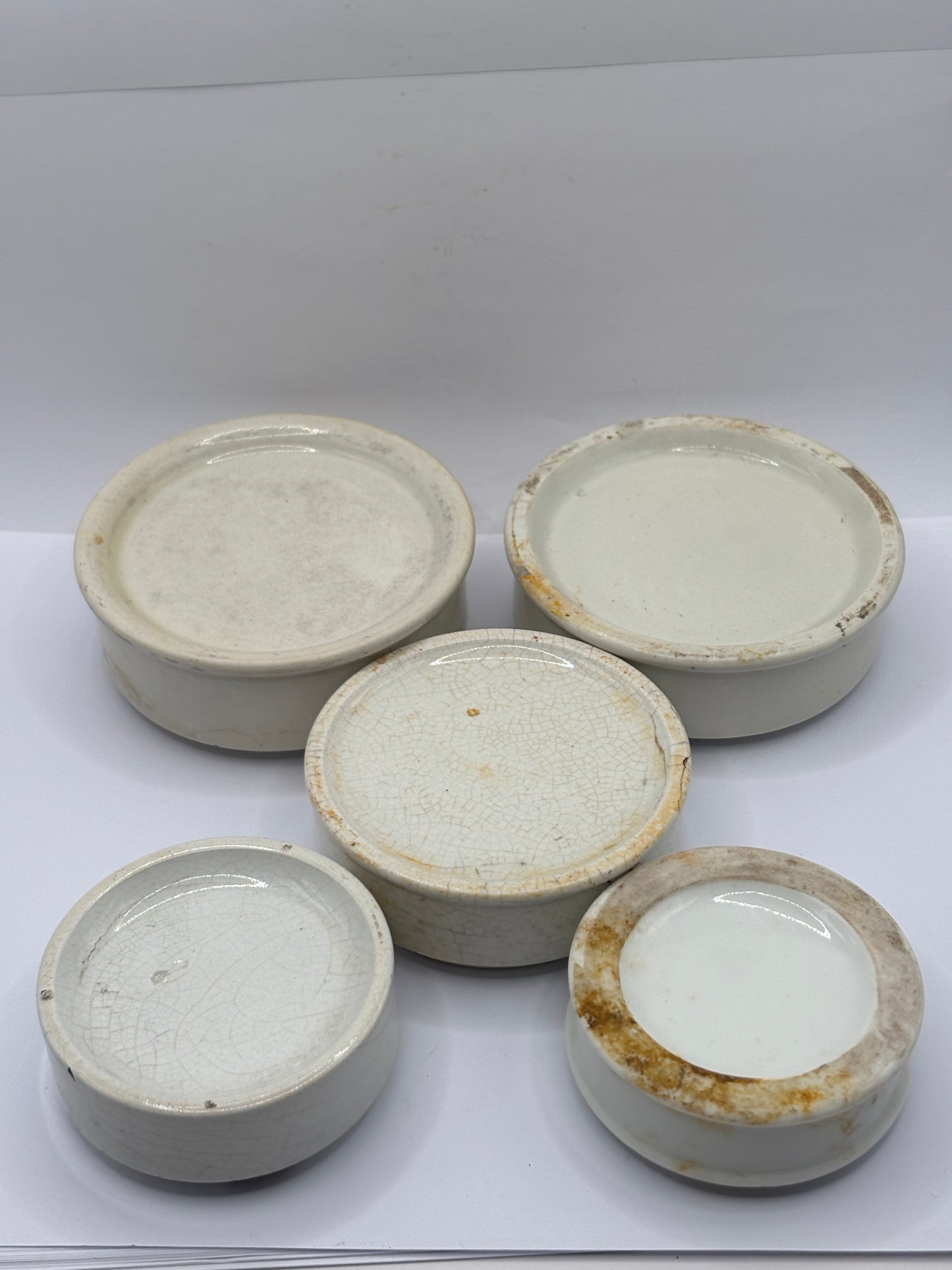 5 plain stoneware bases, stackers. Chipped
