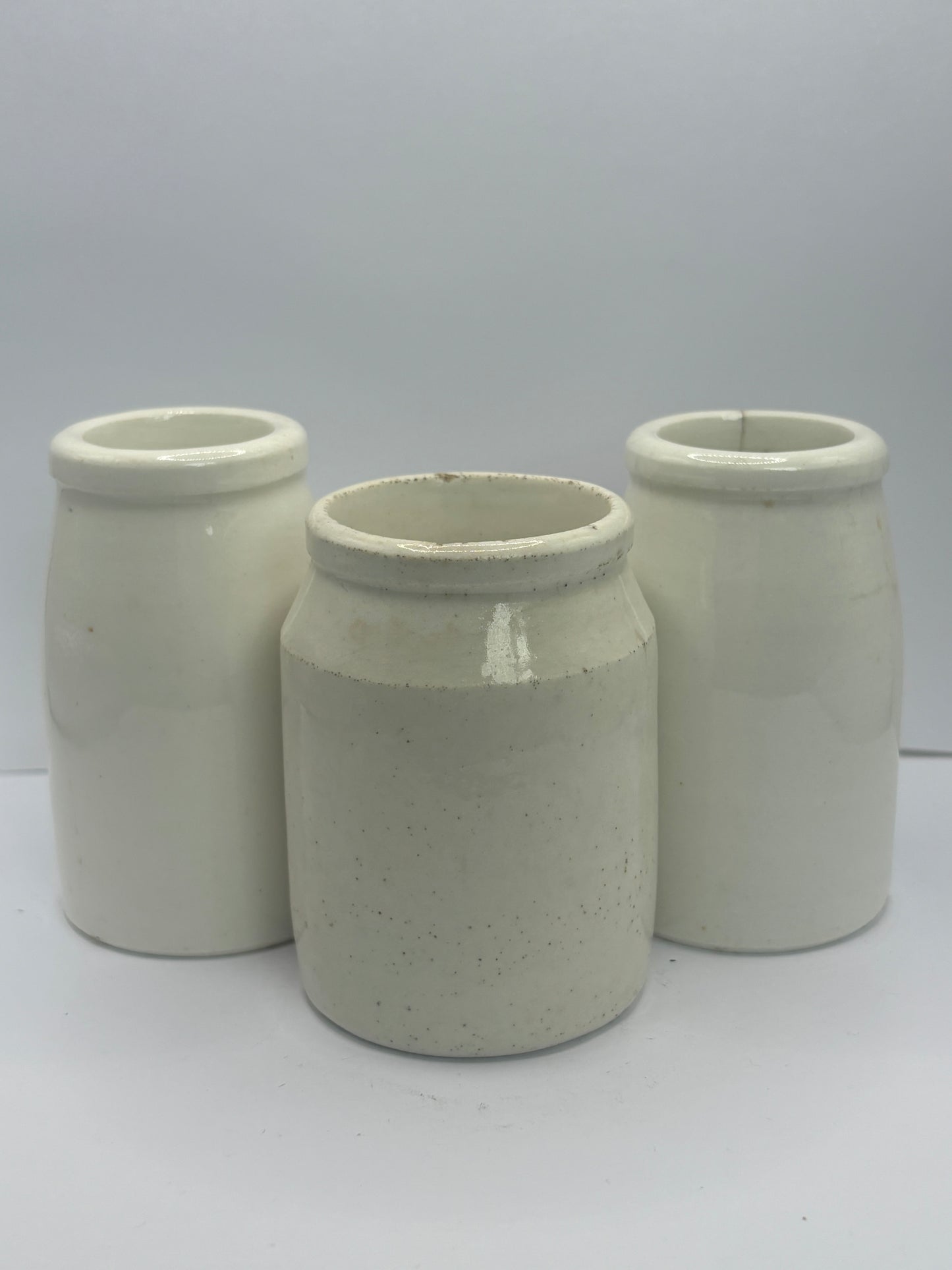 3 small white stoneware pots