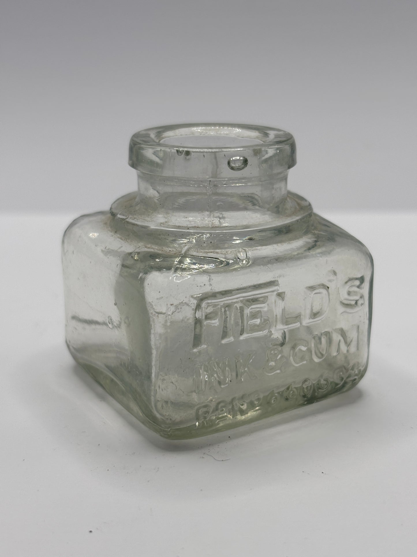 Old clear glass ink bottle, inkwell. fields ink & gum