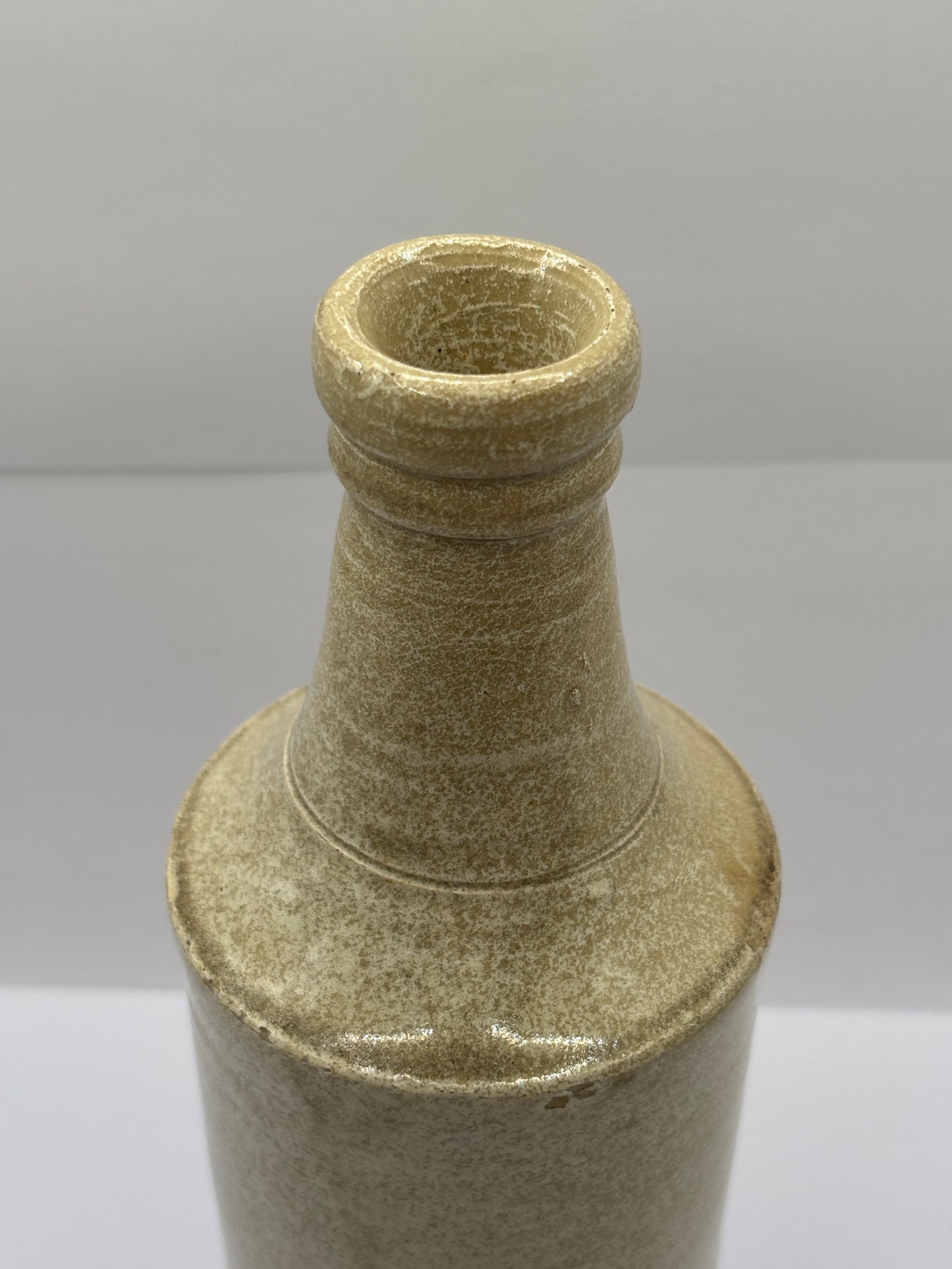 Old tall white stoneware porter bottle