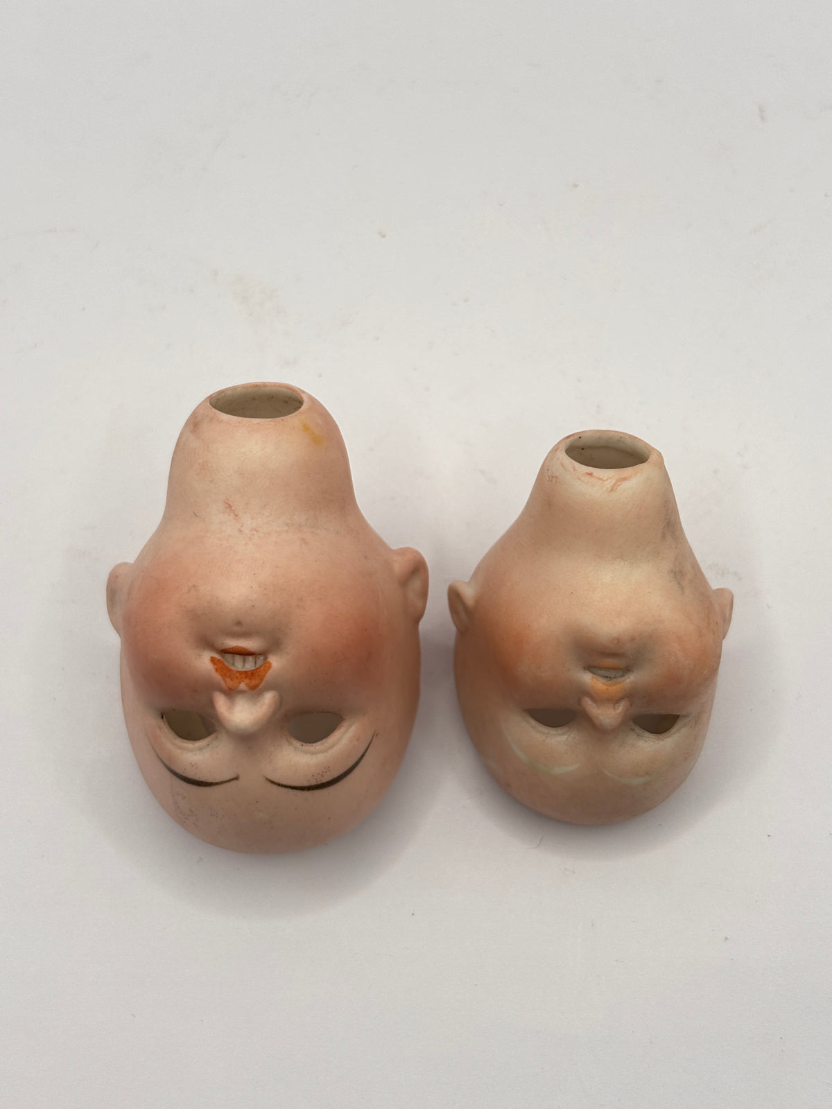 2 Old small bisque dolls heads. Damaged