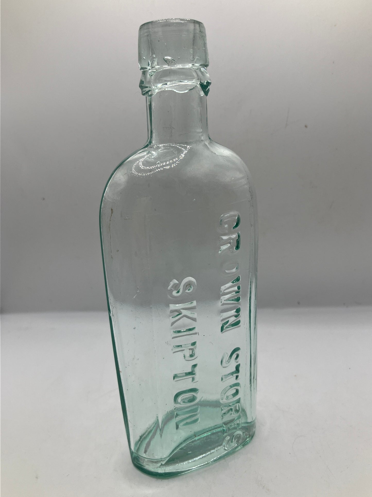 Aqua glass advertising spirit flask, Skipton