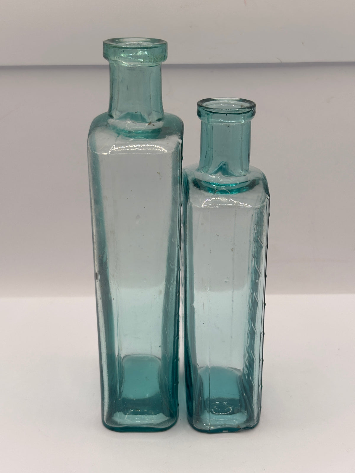 2 old aqua glass medicine bottles, table spoons