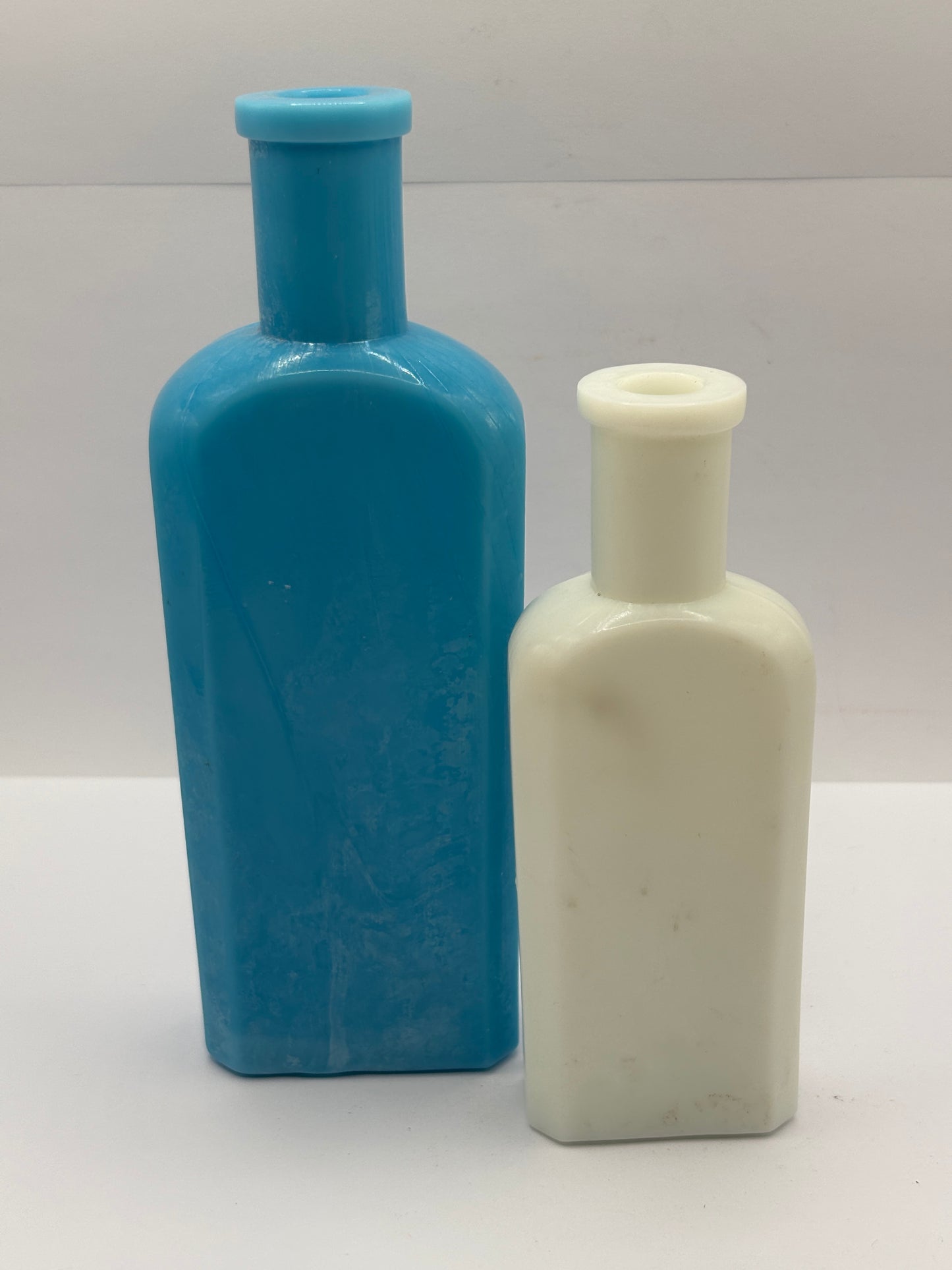 2 old milk glass bottles