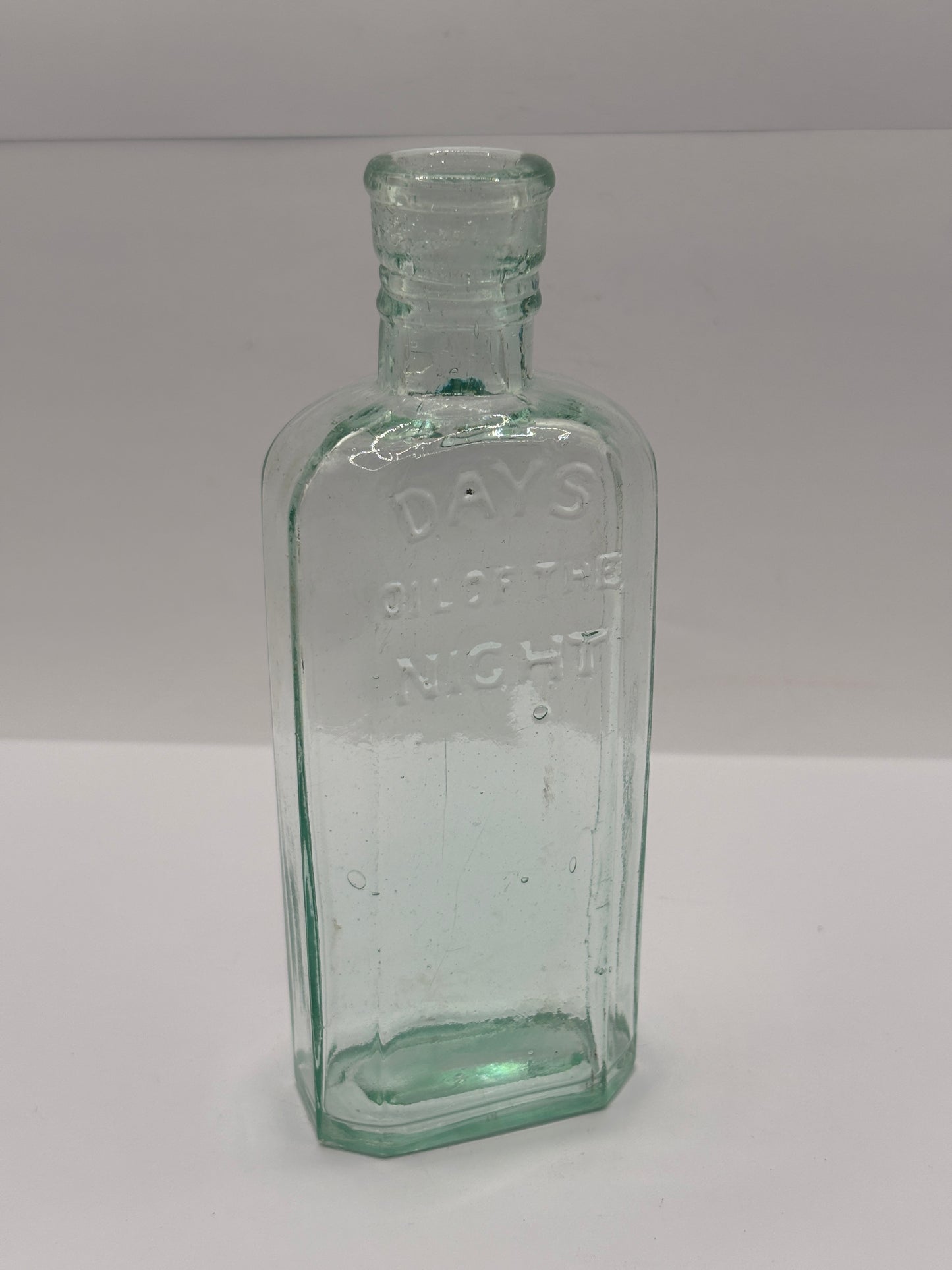 Old glass advertising chemist bottle, Days oil of the night