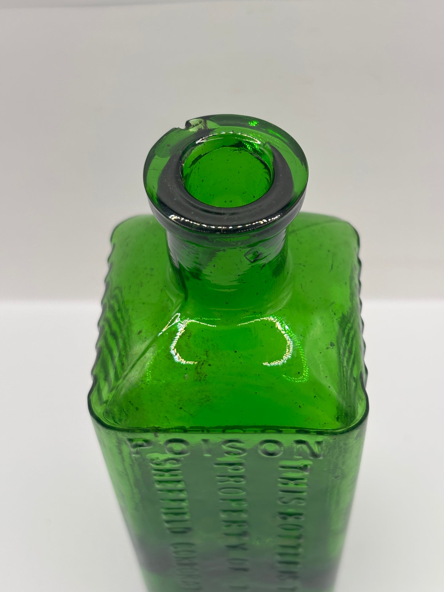Old green glass poison bottle, Sheffield corporation poison bottle. Chipped