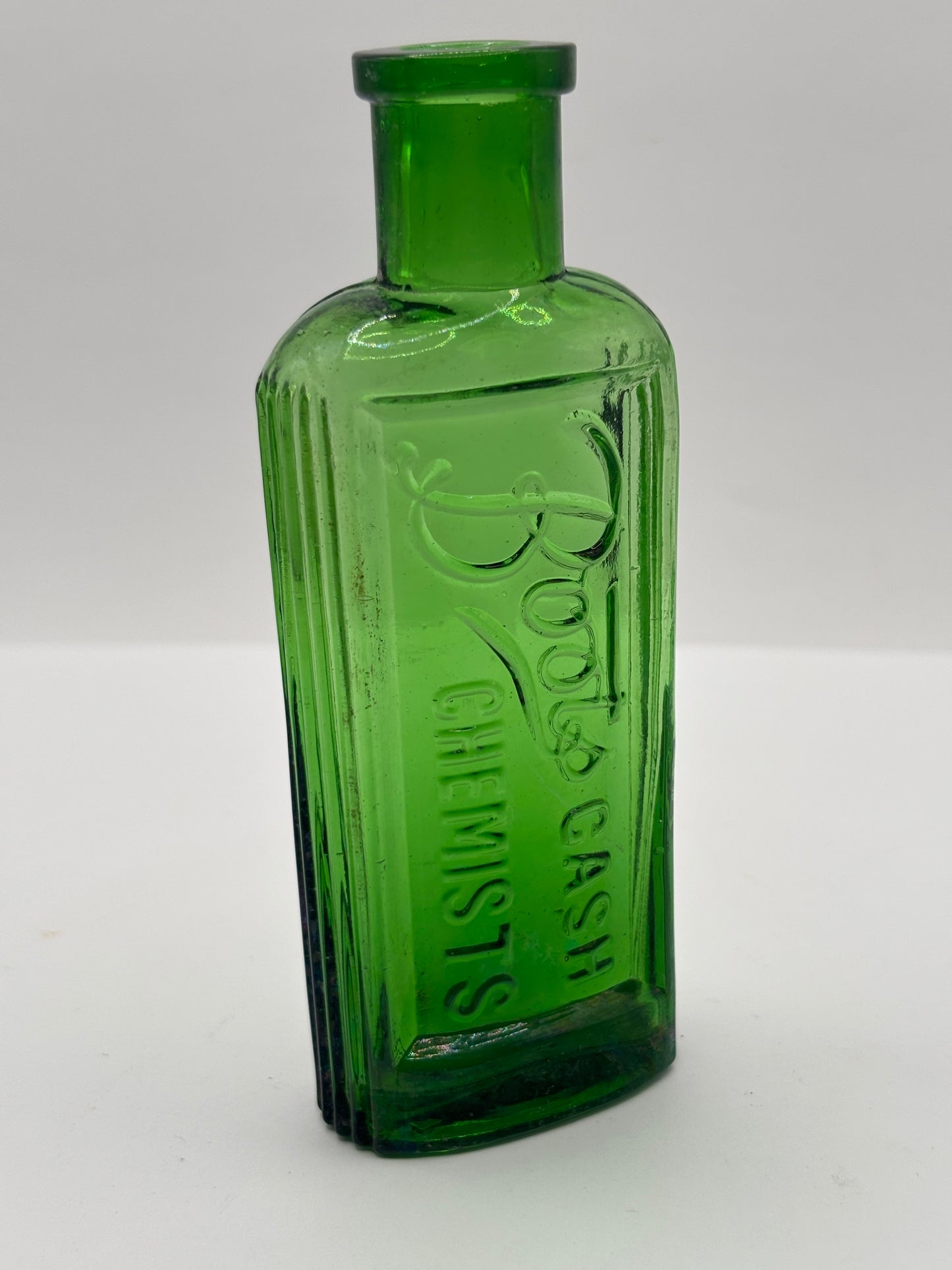 Old green glass advertising bottle. Boots Cash Chemists