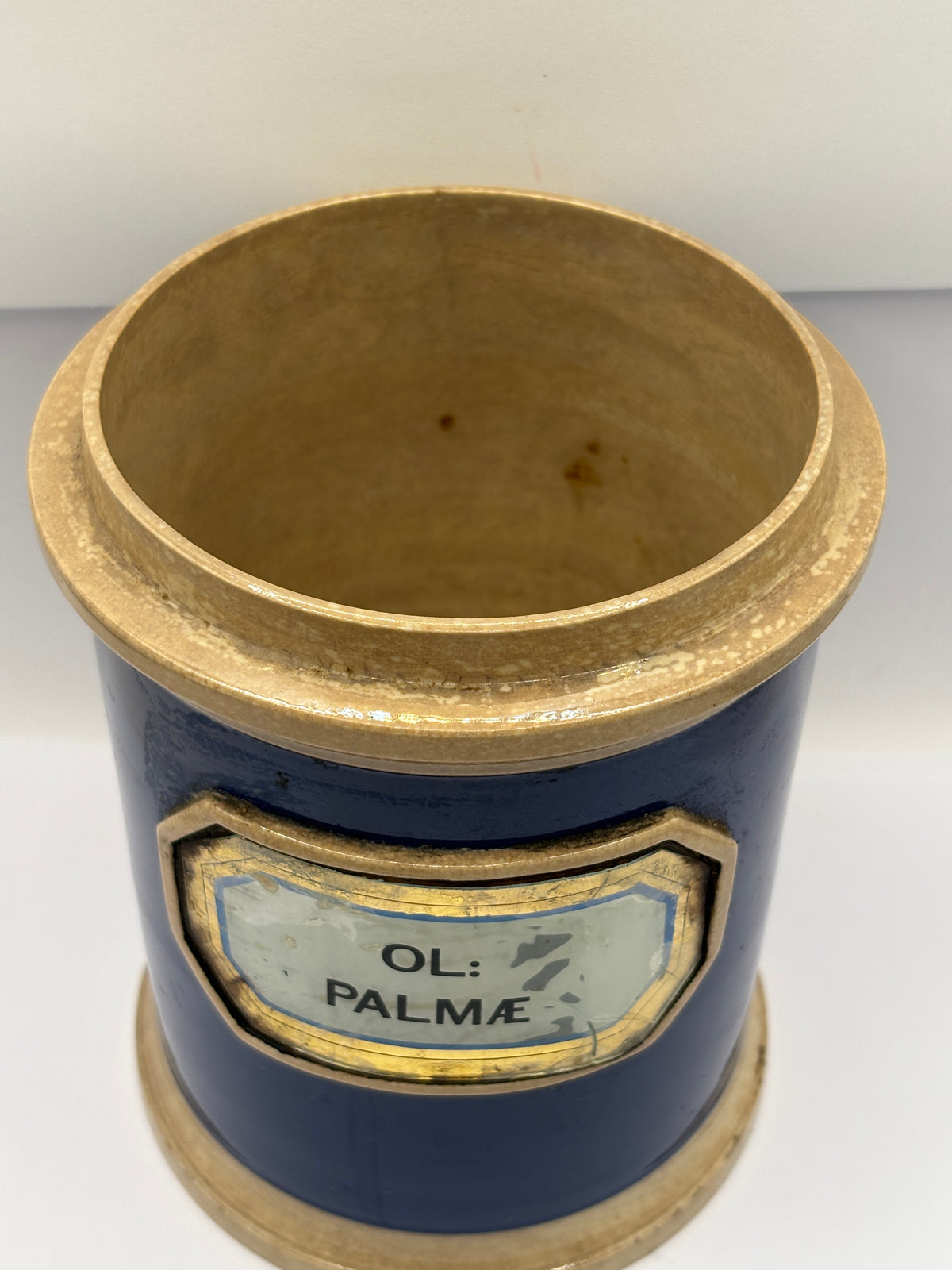 Old plain blue stoneware apothecary jar with glass label
