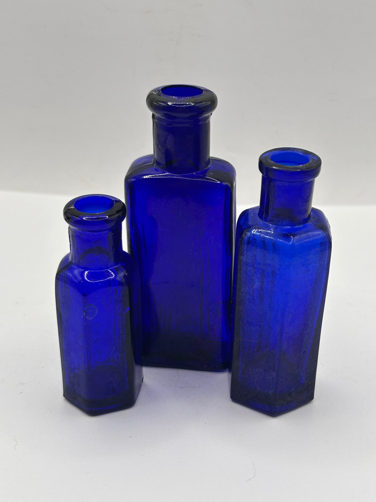 3 old small blue ribbed poison bottles, not to be taken