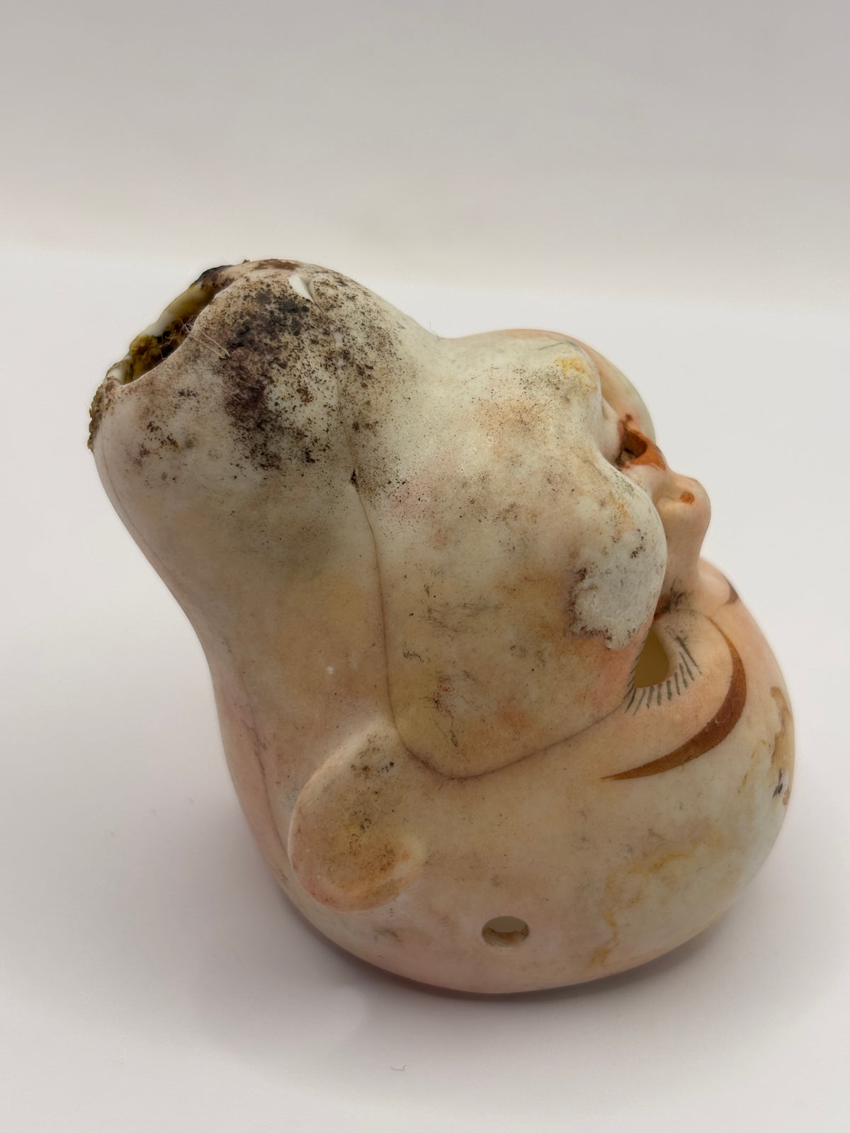 Old super stained bisque dolls head, damaged