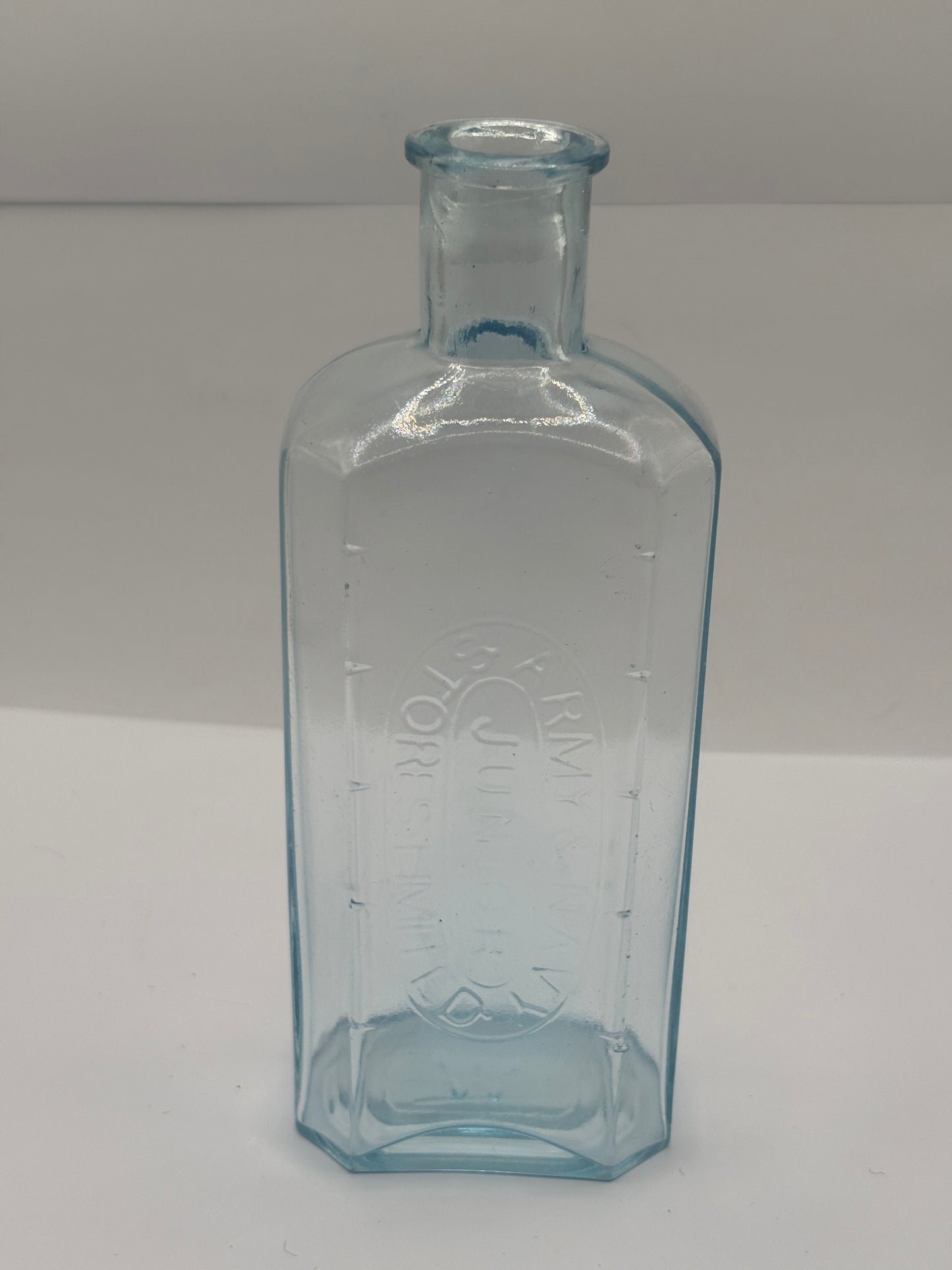 Old advertising chemist bottle. Army & navy junior stores