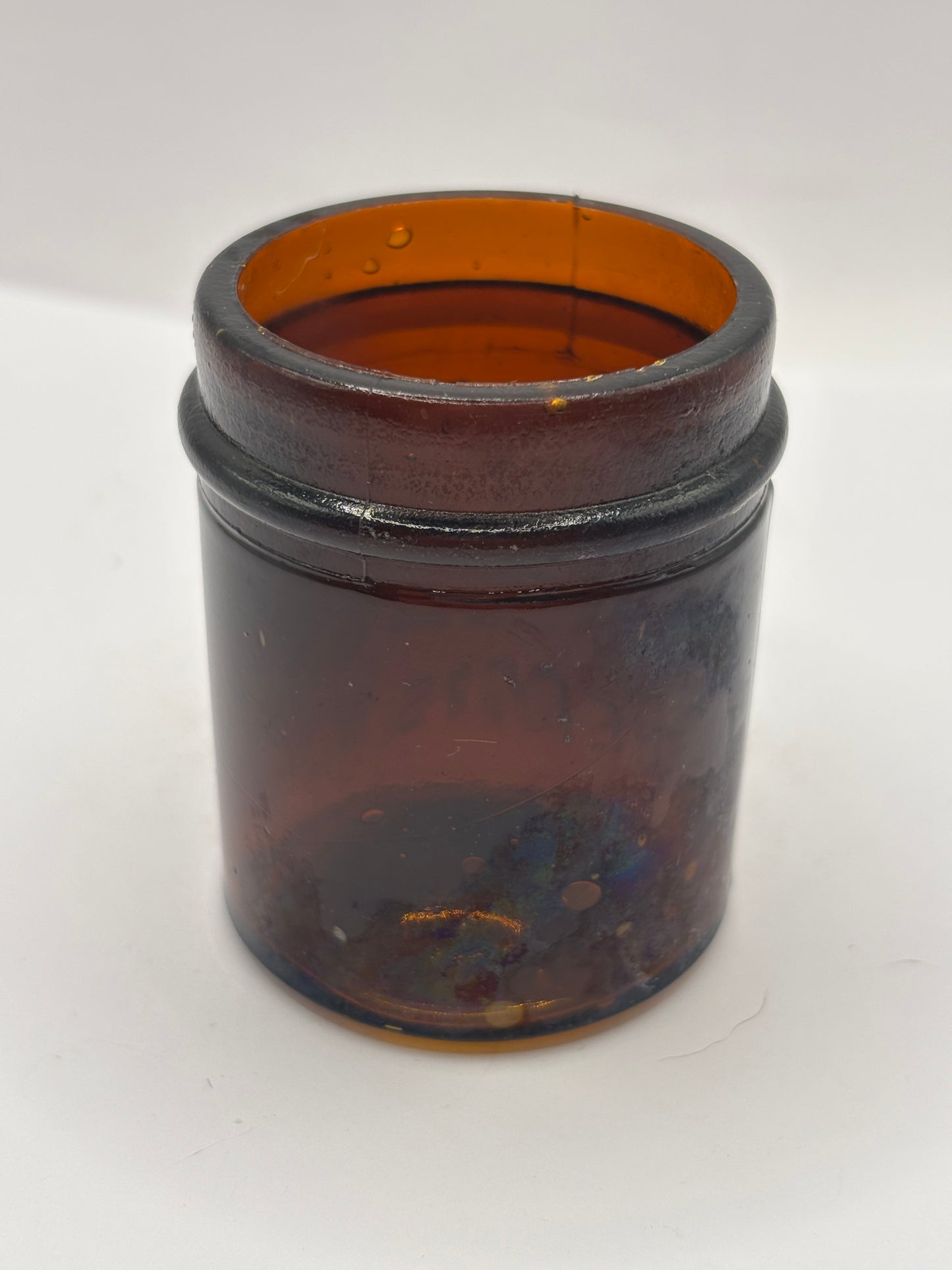 Small old amber glass boots jar