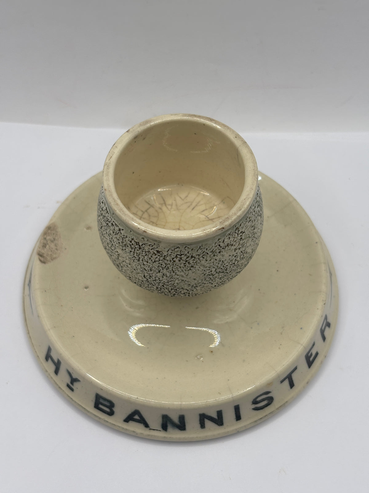 Old advertising stoneware match striker. HY Bannister Manchester