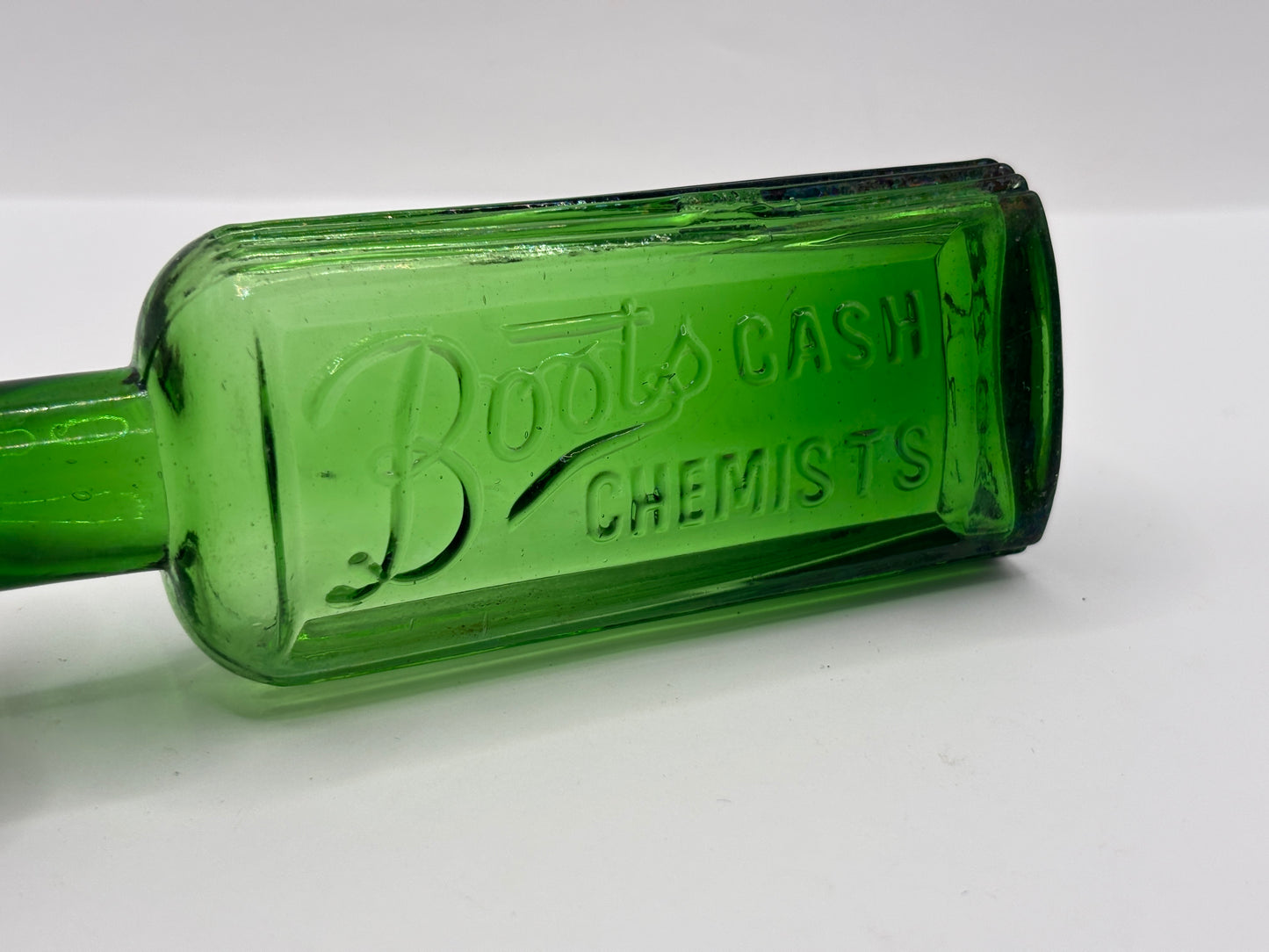 Old green glass advertising bottle. Boots Cash Chemists