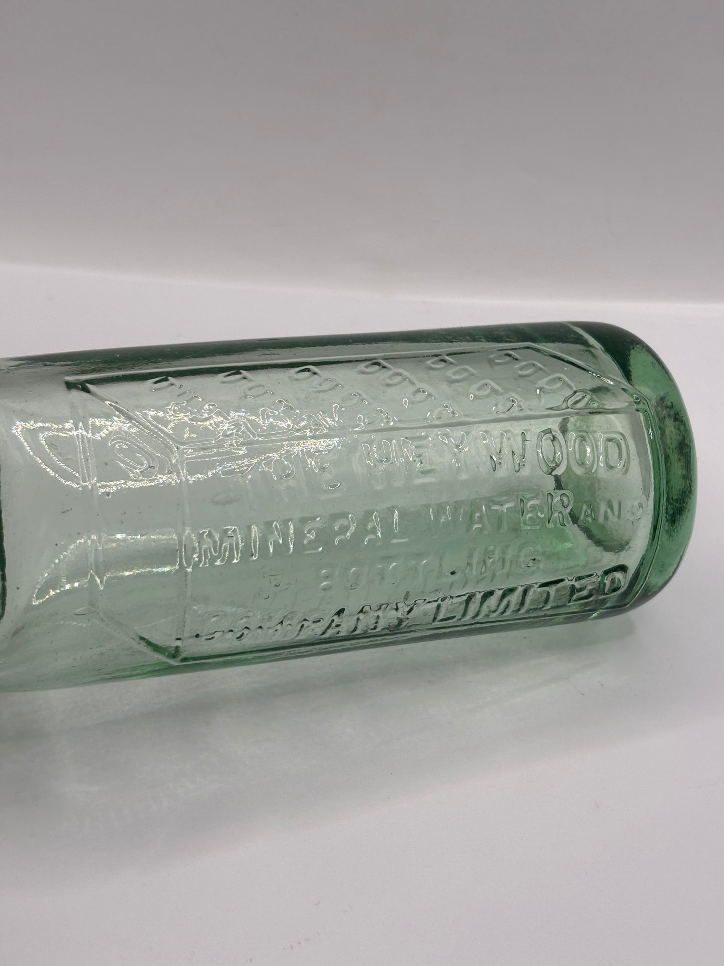 Old glass codd bottle, with marble. The Heywood mineral water bottling co