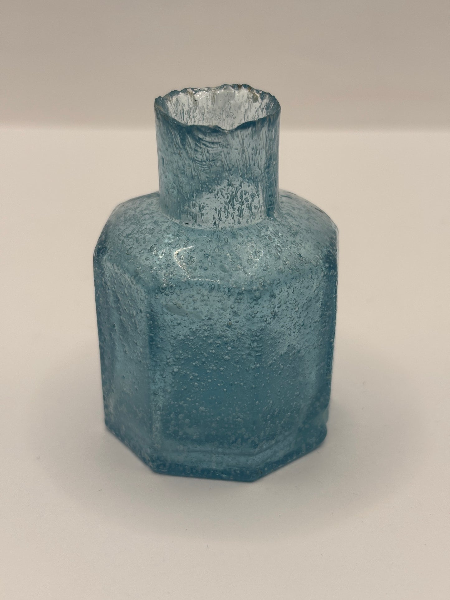 Old blue glass inkwell, ink bottle, penny ink. Lots of air bubbles