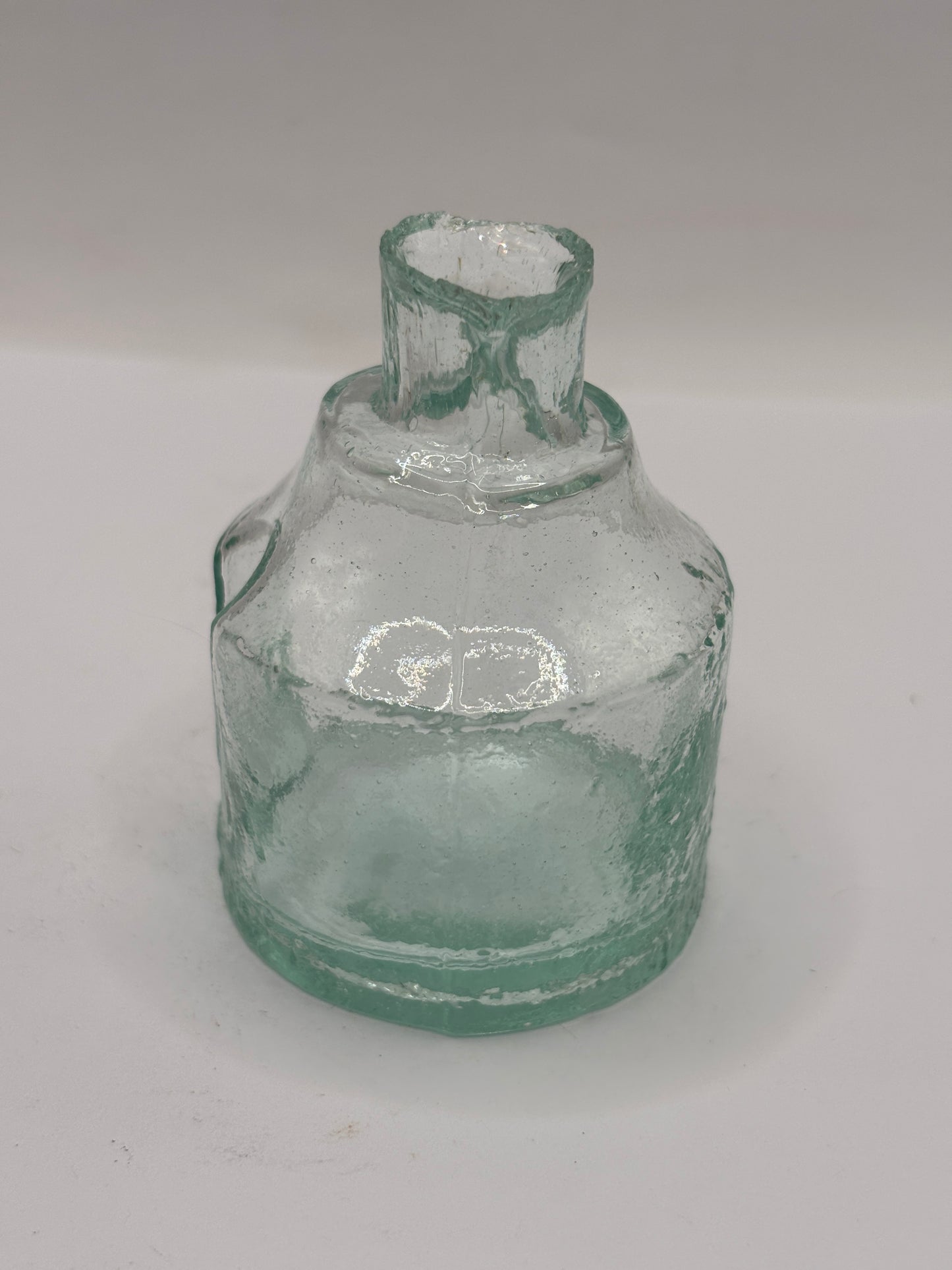 Old aqua glass inkwell. Ink bottle with pen rest