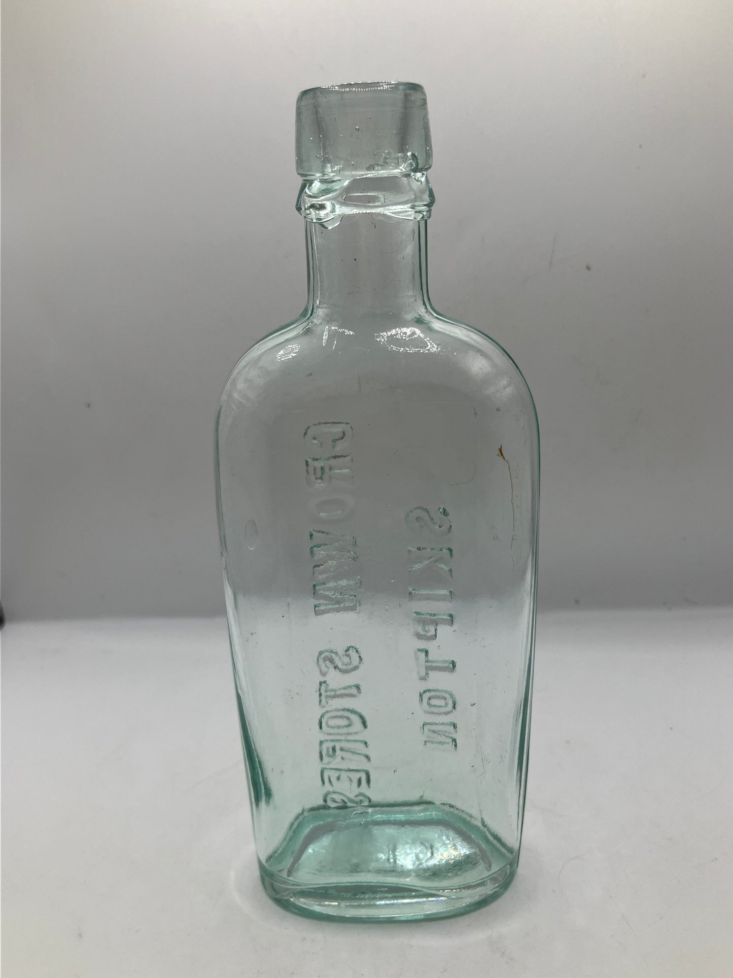 Aqua glass advertising spirit flask, Skipton