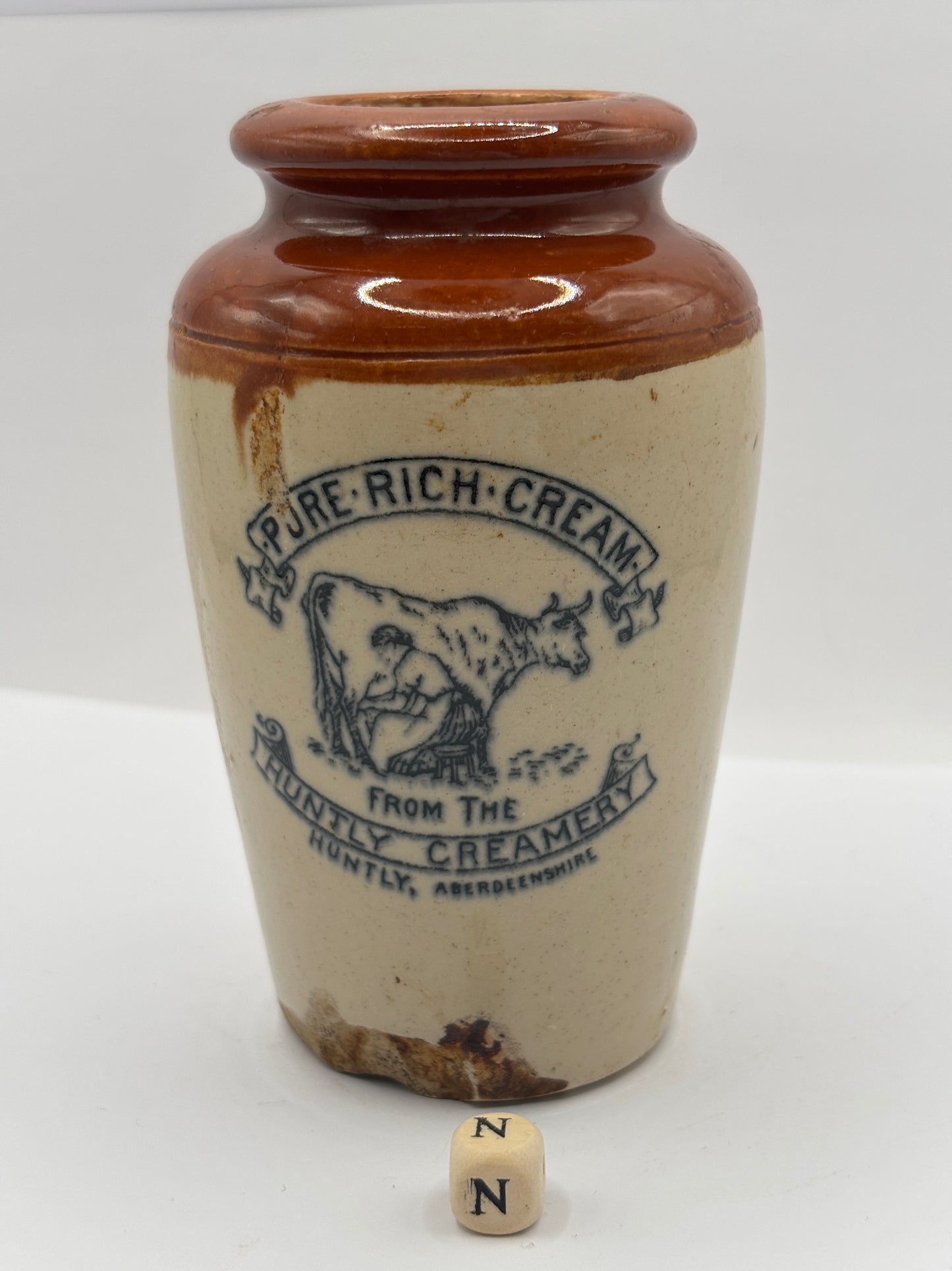 Old advertising cream pot, Huntly creamery. Milk maid. Pure rich cream. Damaged (N)