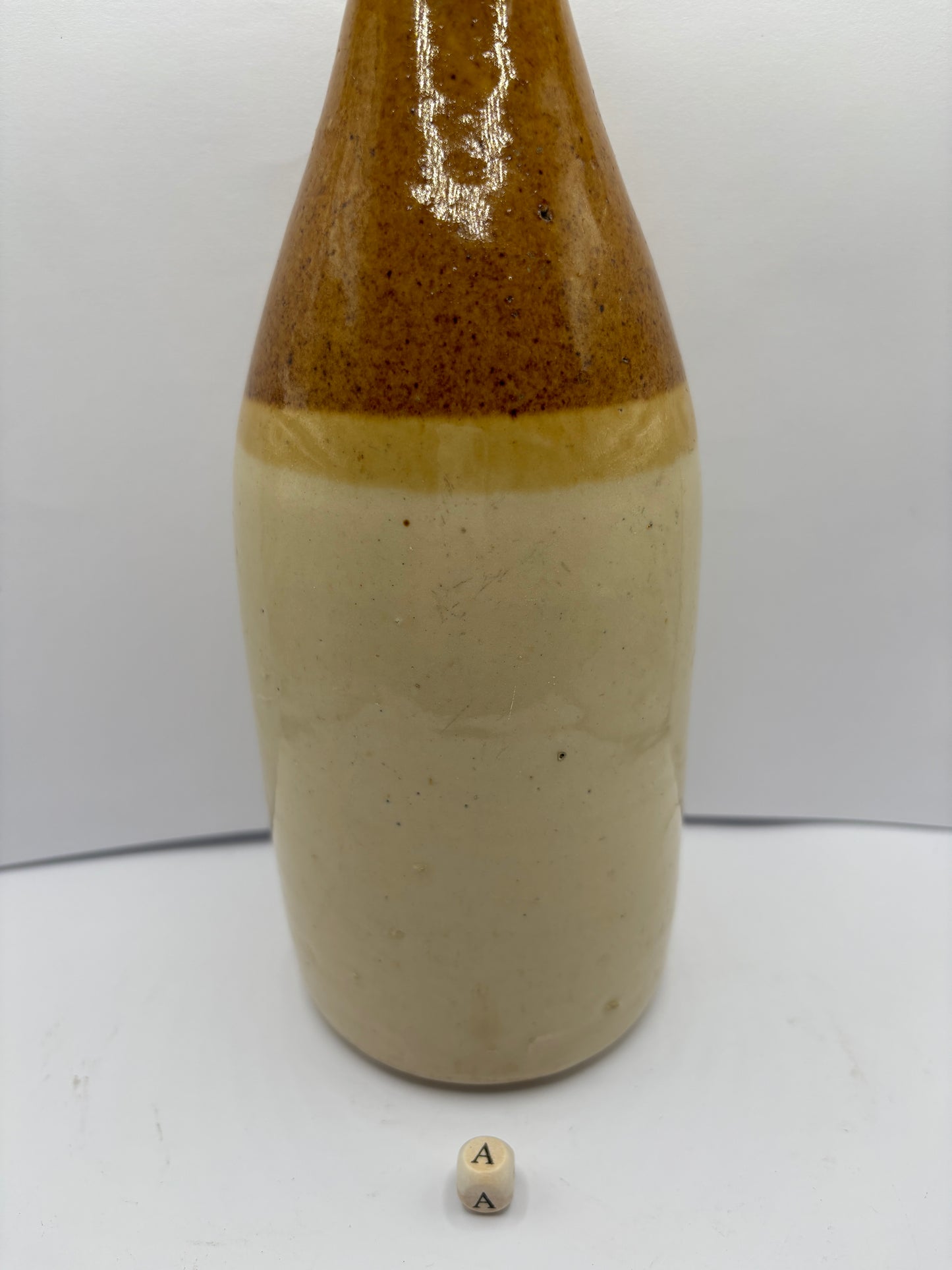 Large plain stoneware ginger beer bottle (a)