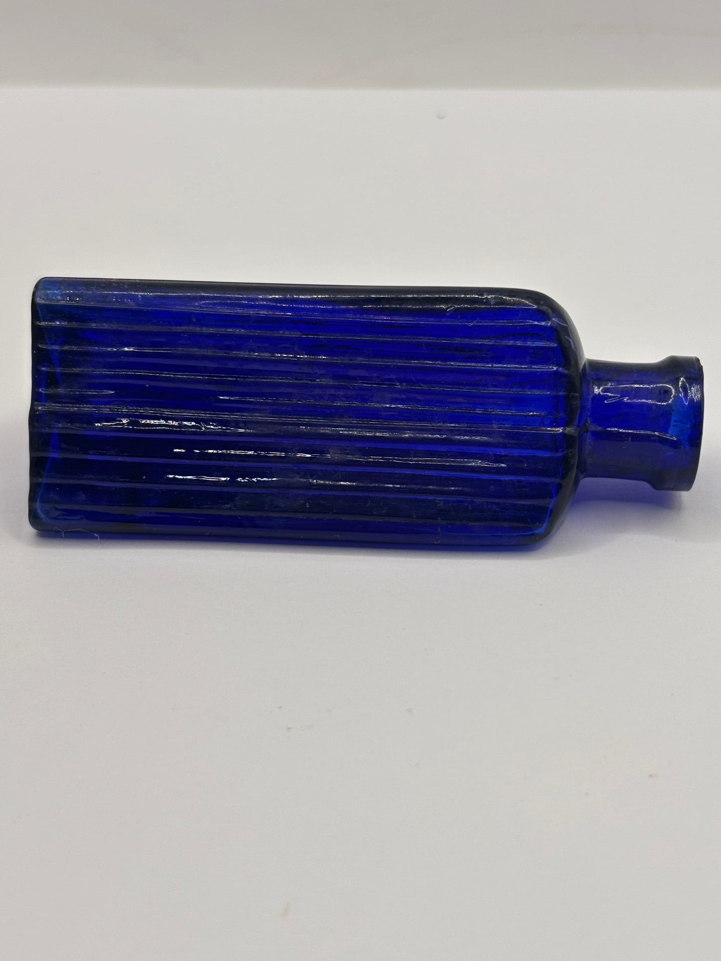 Old small blue triangular poison bottle