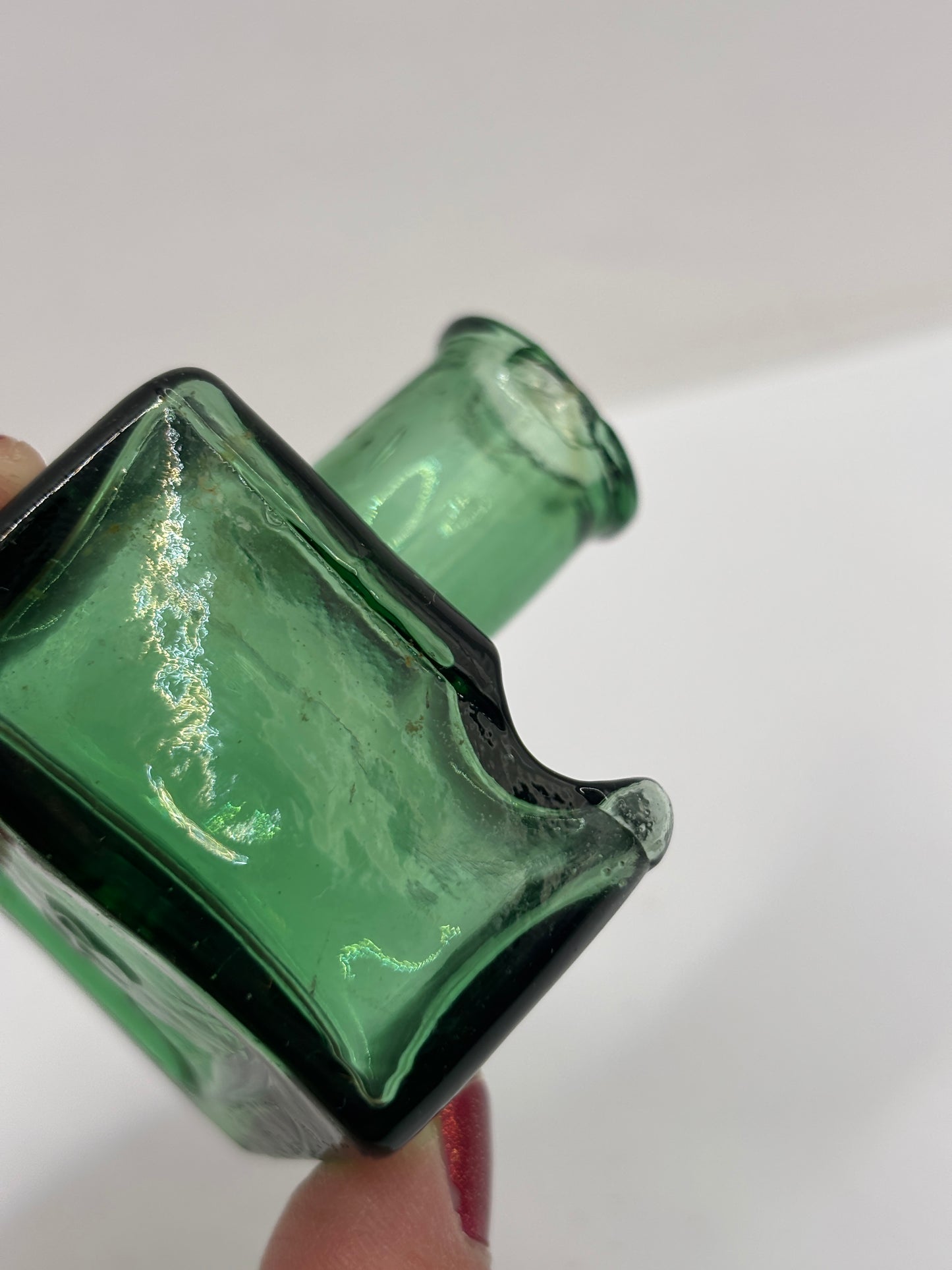 Old green glass ink bottle, inkwell. With pen rest (BH) chipped