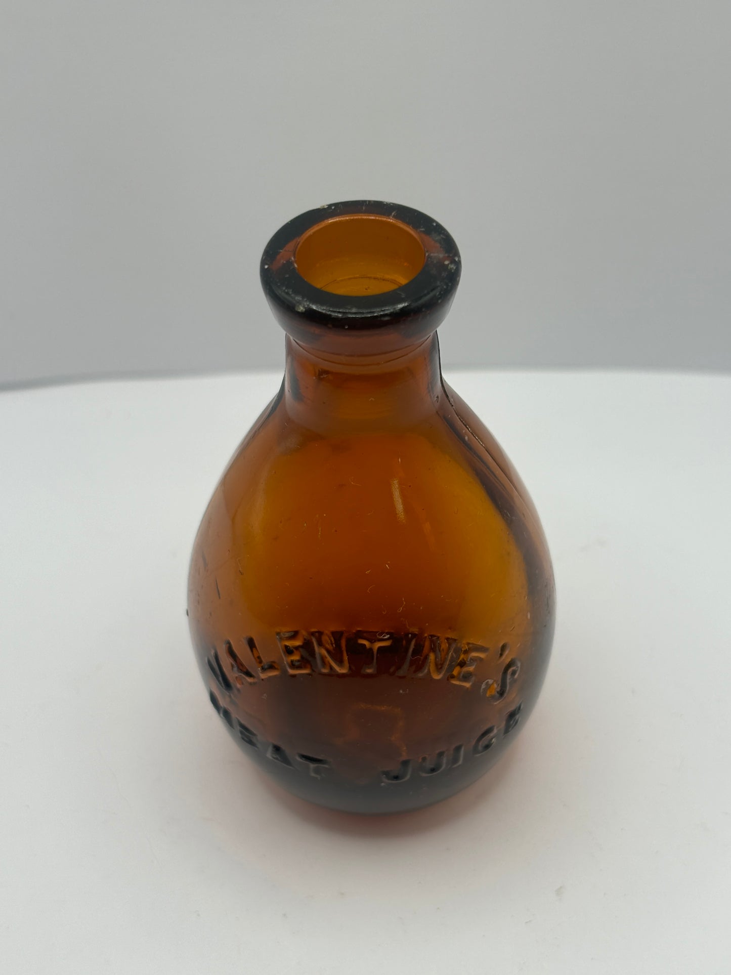 Small old amber glass valentines meat juices bottle