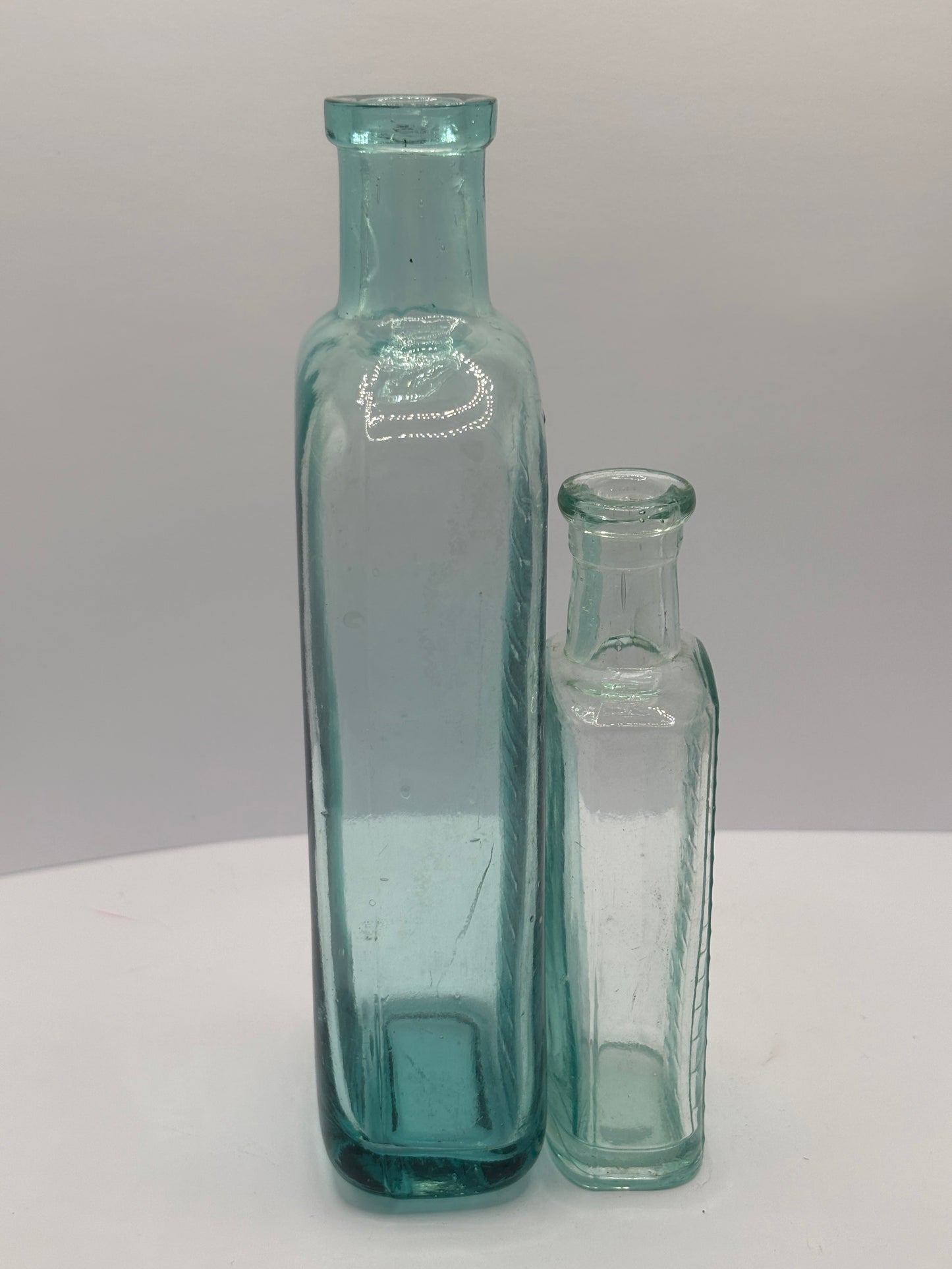 2 old aqua glass tablespoon & teaspoon bottles