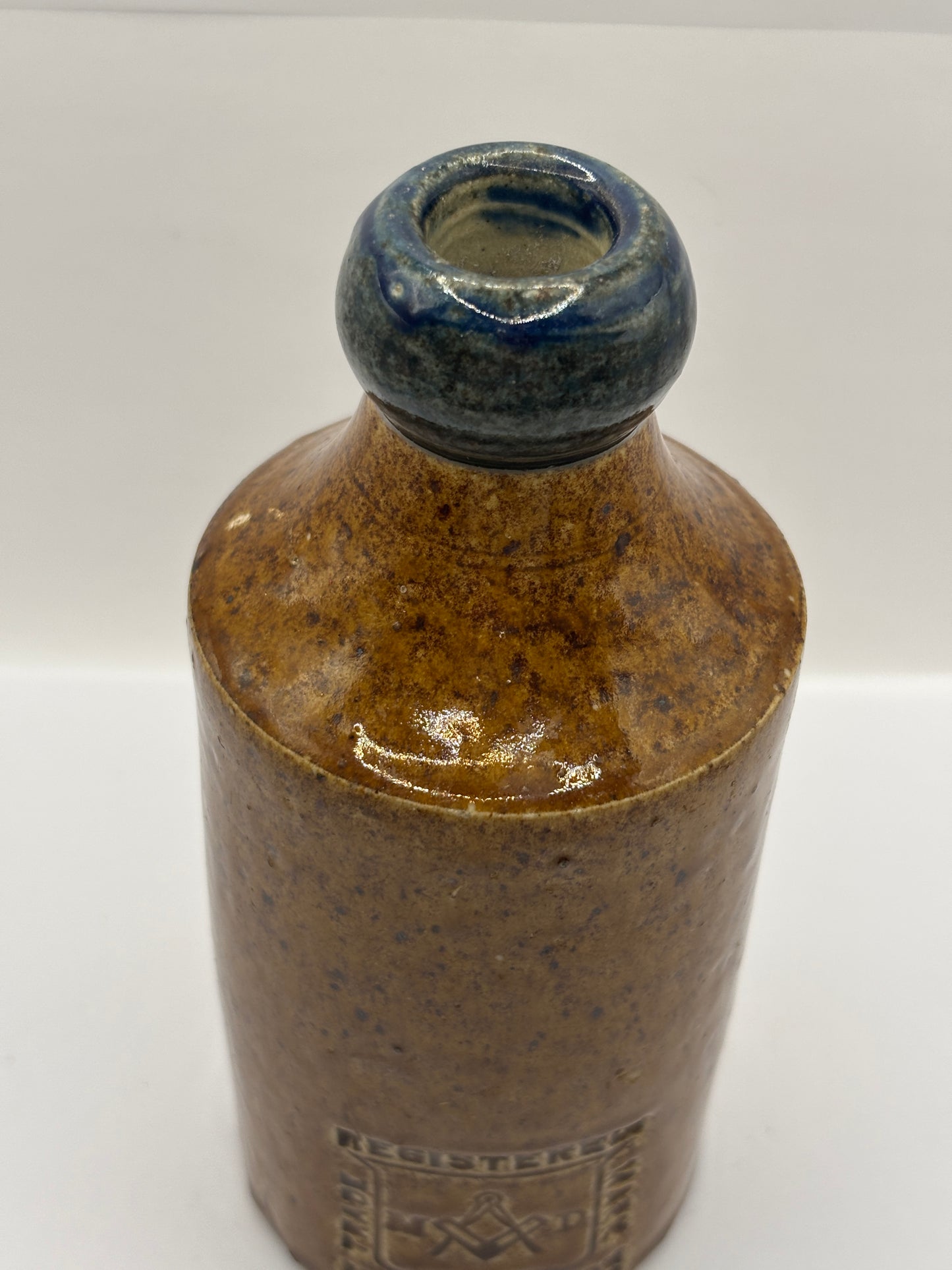 Old Blue top impressed stoneware ginger beer bottle, Manchester