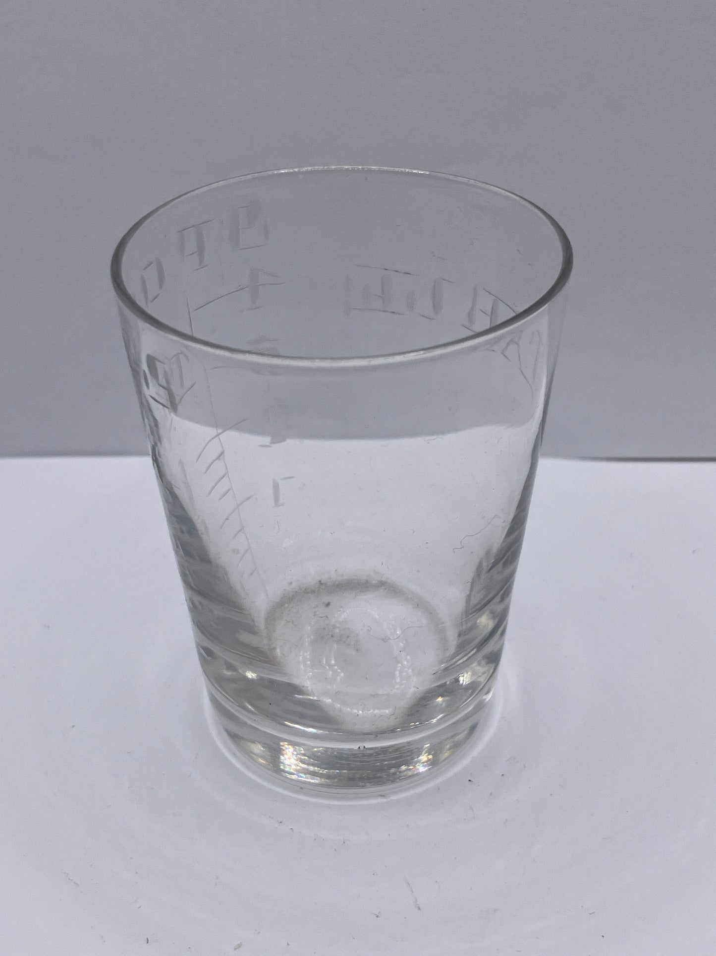 Old chemist measuring glass