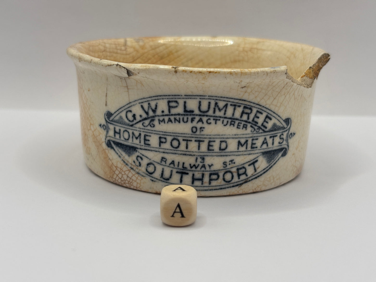 Old advertising meat paste pot, plumtrees (a) damaged