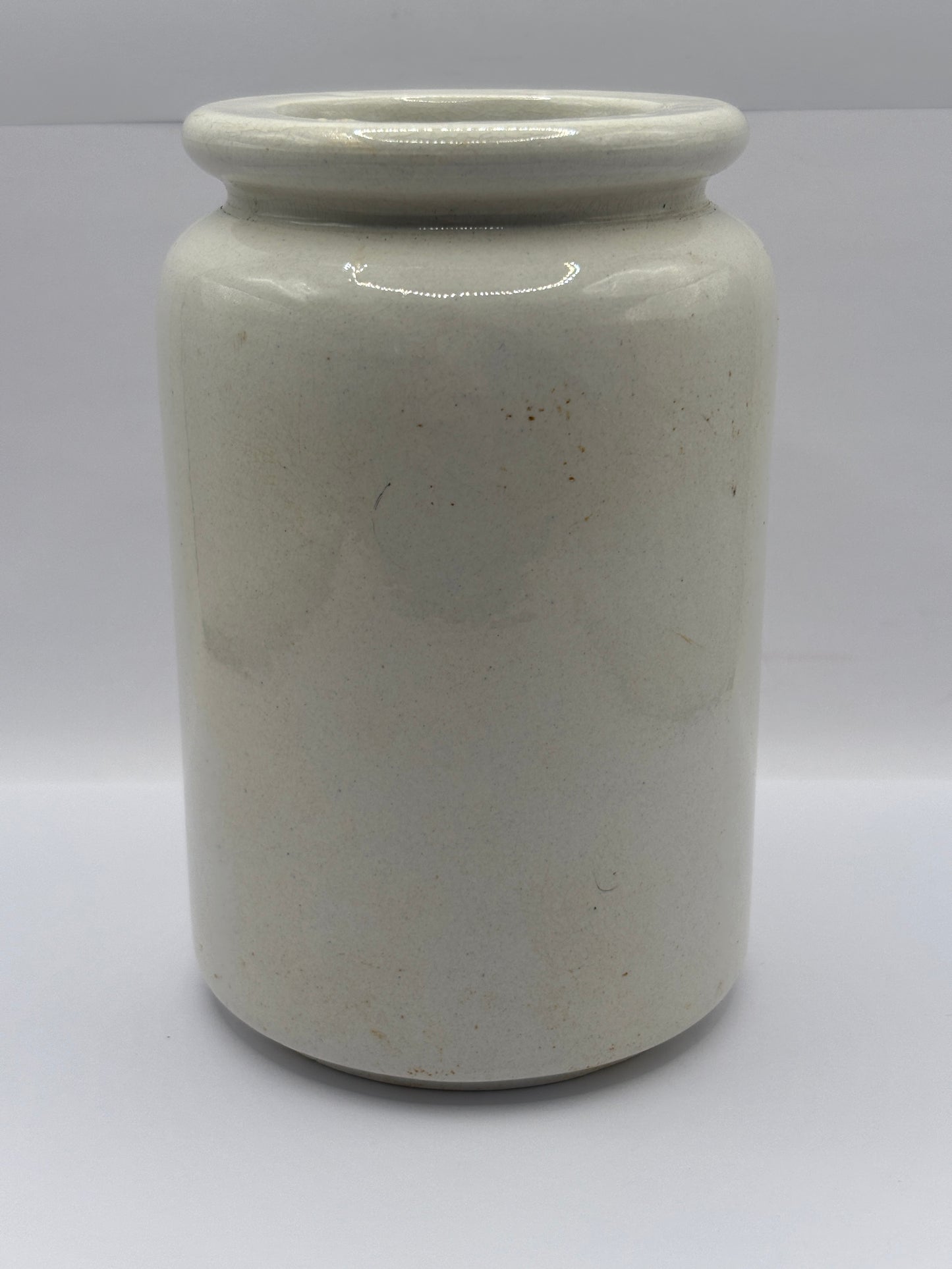 Old tall white rolled top stoneware jar