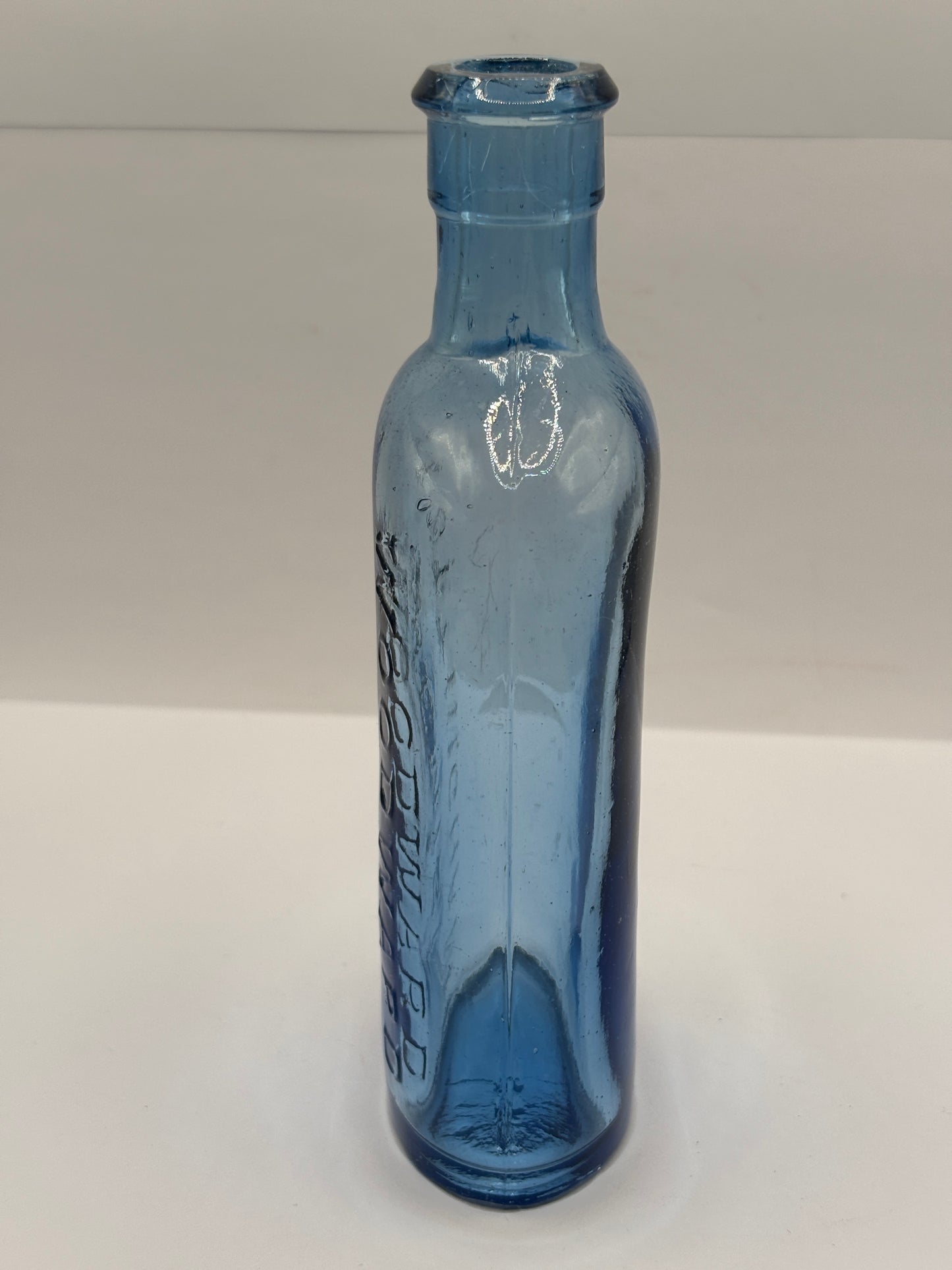 Old blue glass advertising chemist bottle, Woodwards Nottingham