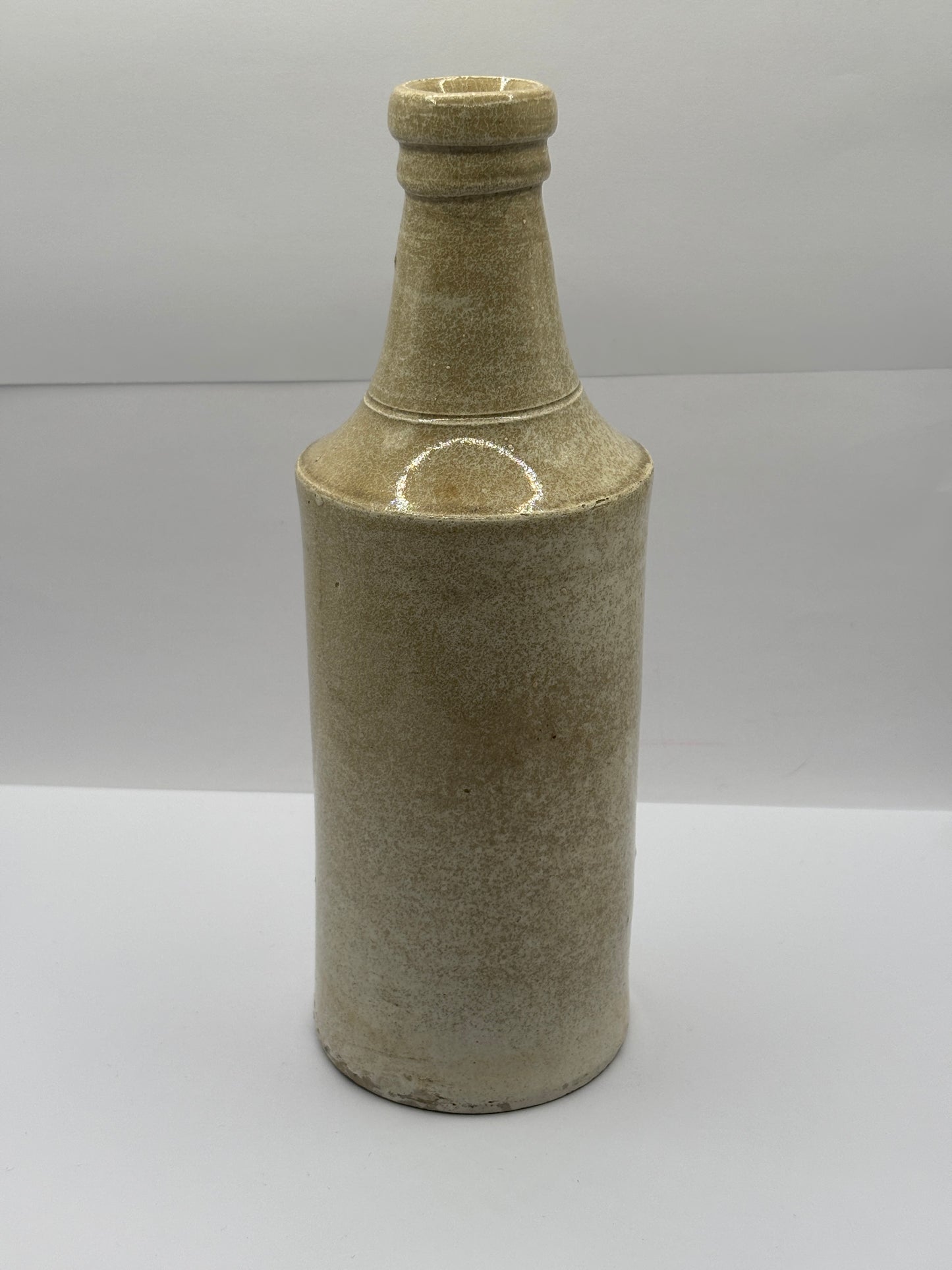Old tall white stoneware porter bottle