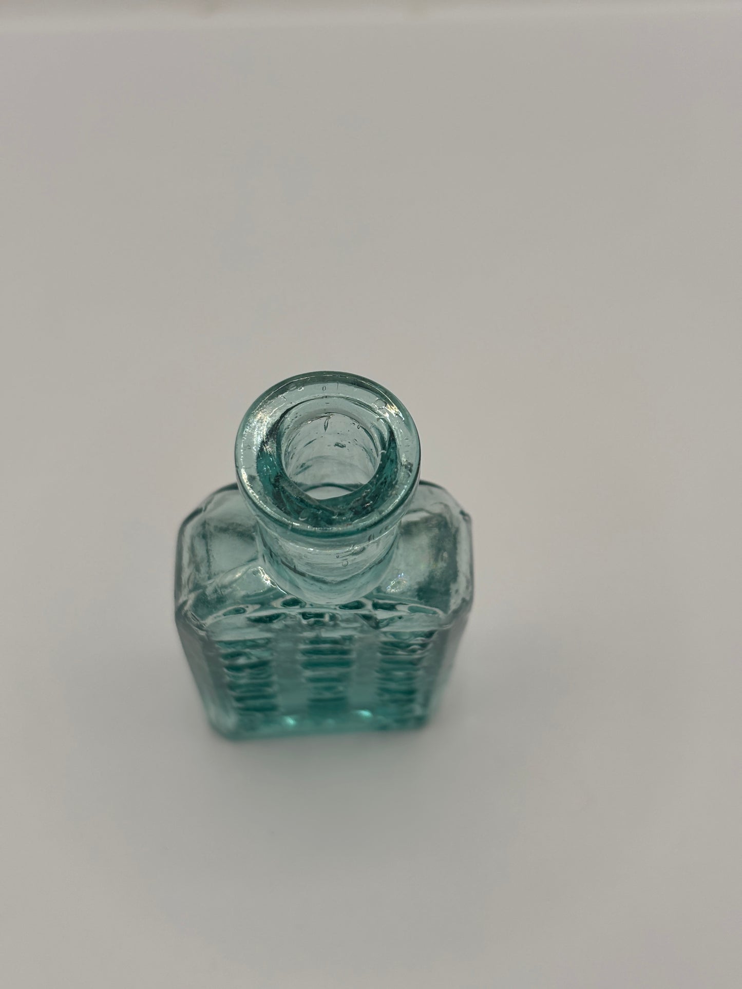 Old small aqua glass advertising bottle. Pritchards teething powders