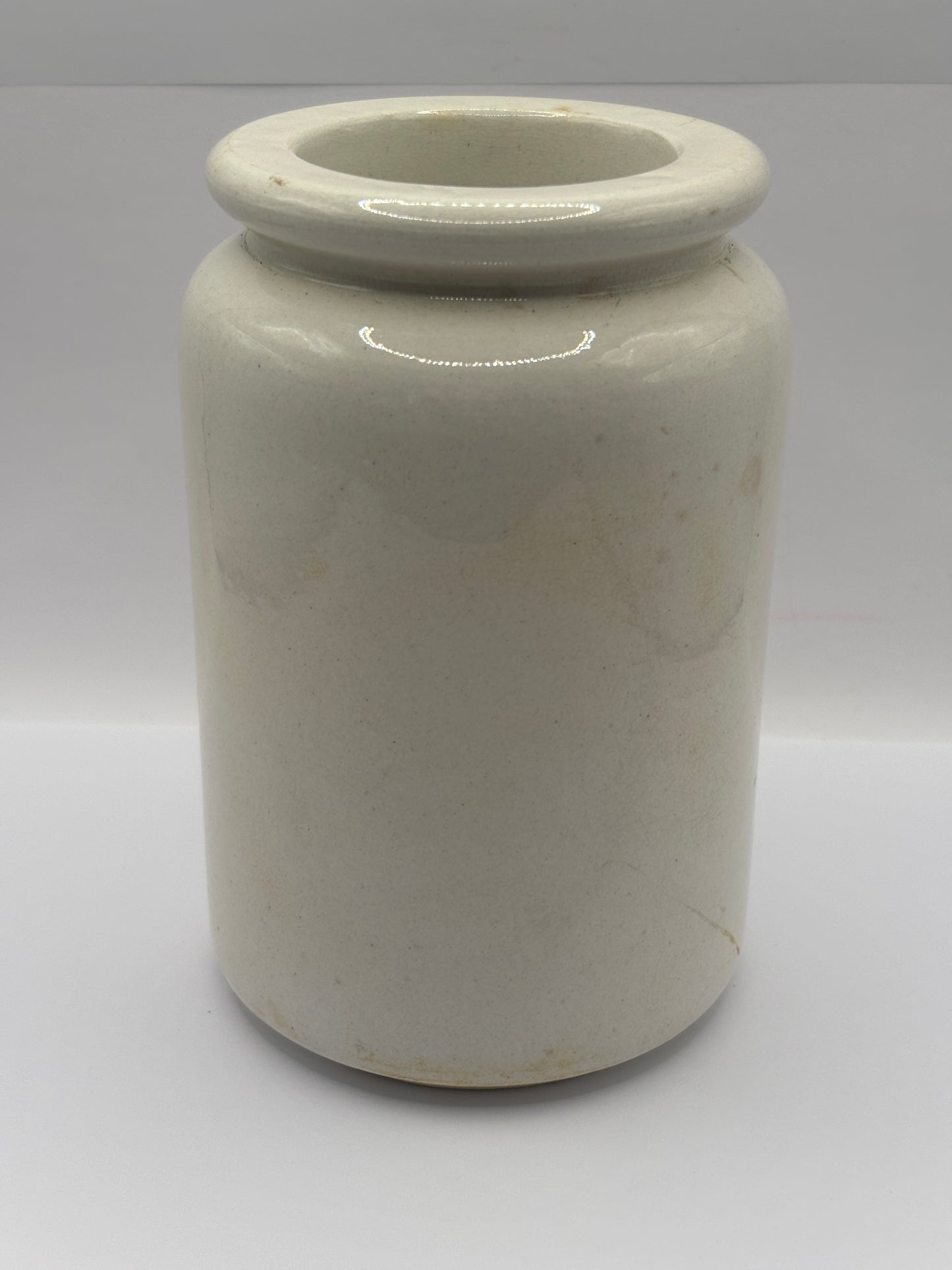 Old tall white rolled top stoneware jar