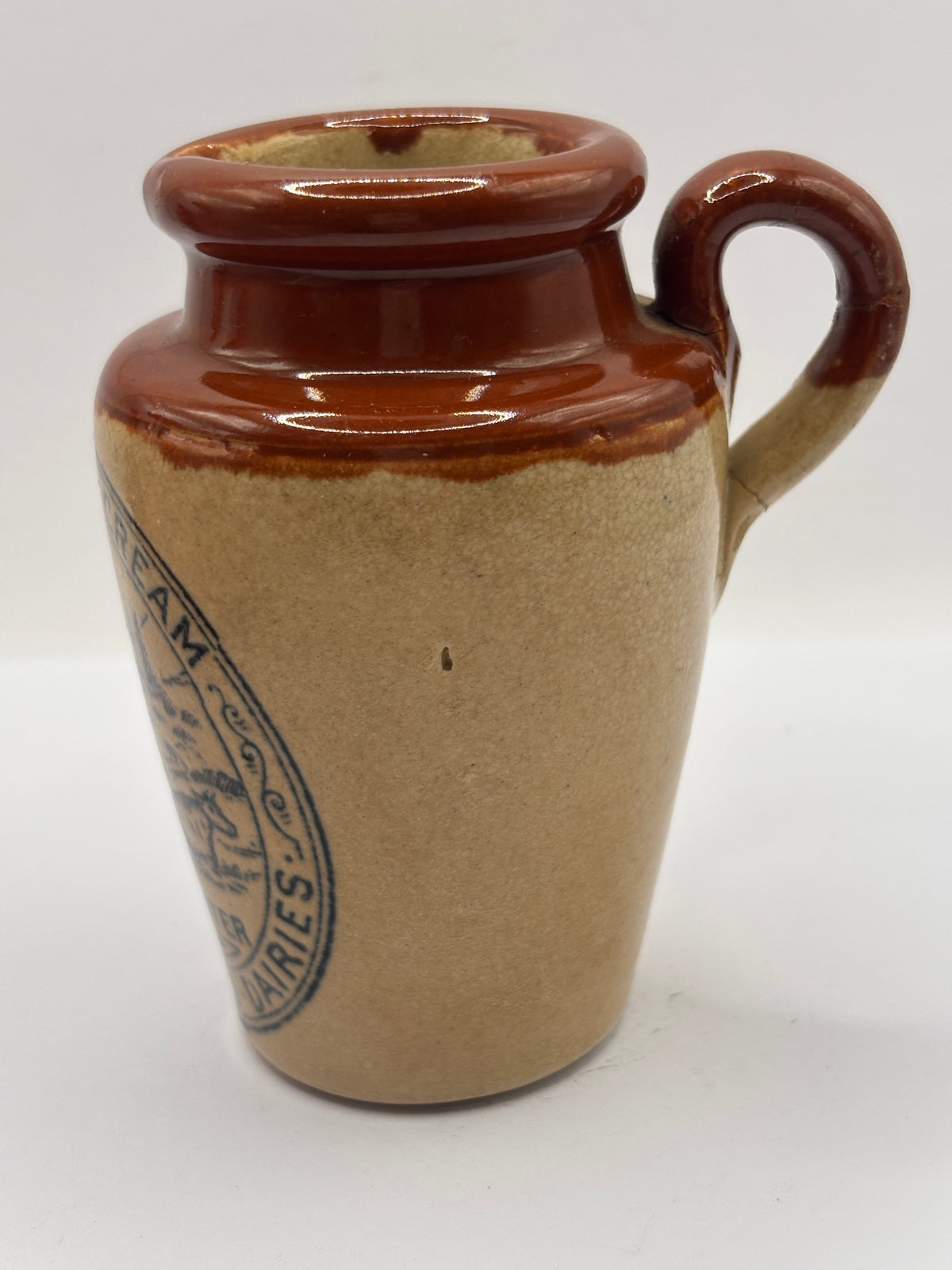 Old advertising cream pot, Bannisters Huddersfield dairies. Repaired handle