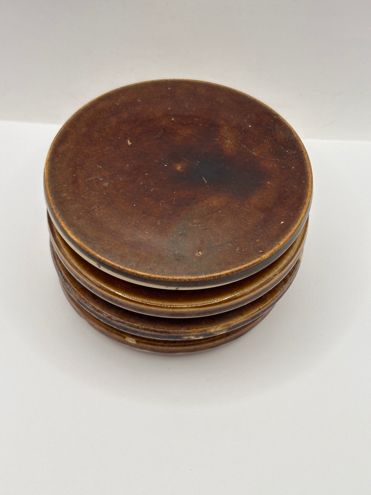 4 old brown stoneware lids, stackers
