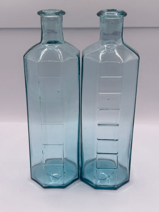 2 old glass medicine bottles