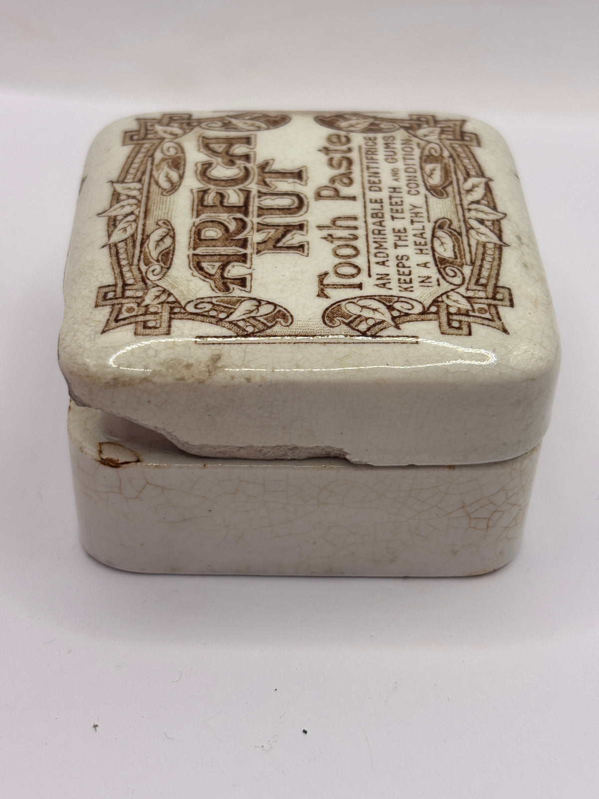 Old advertising lid and base. Areca nut toothpaste. Serpia print. Damaged