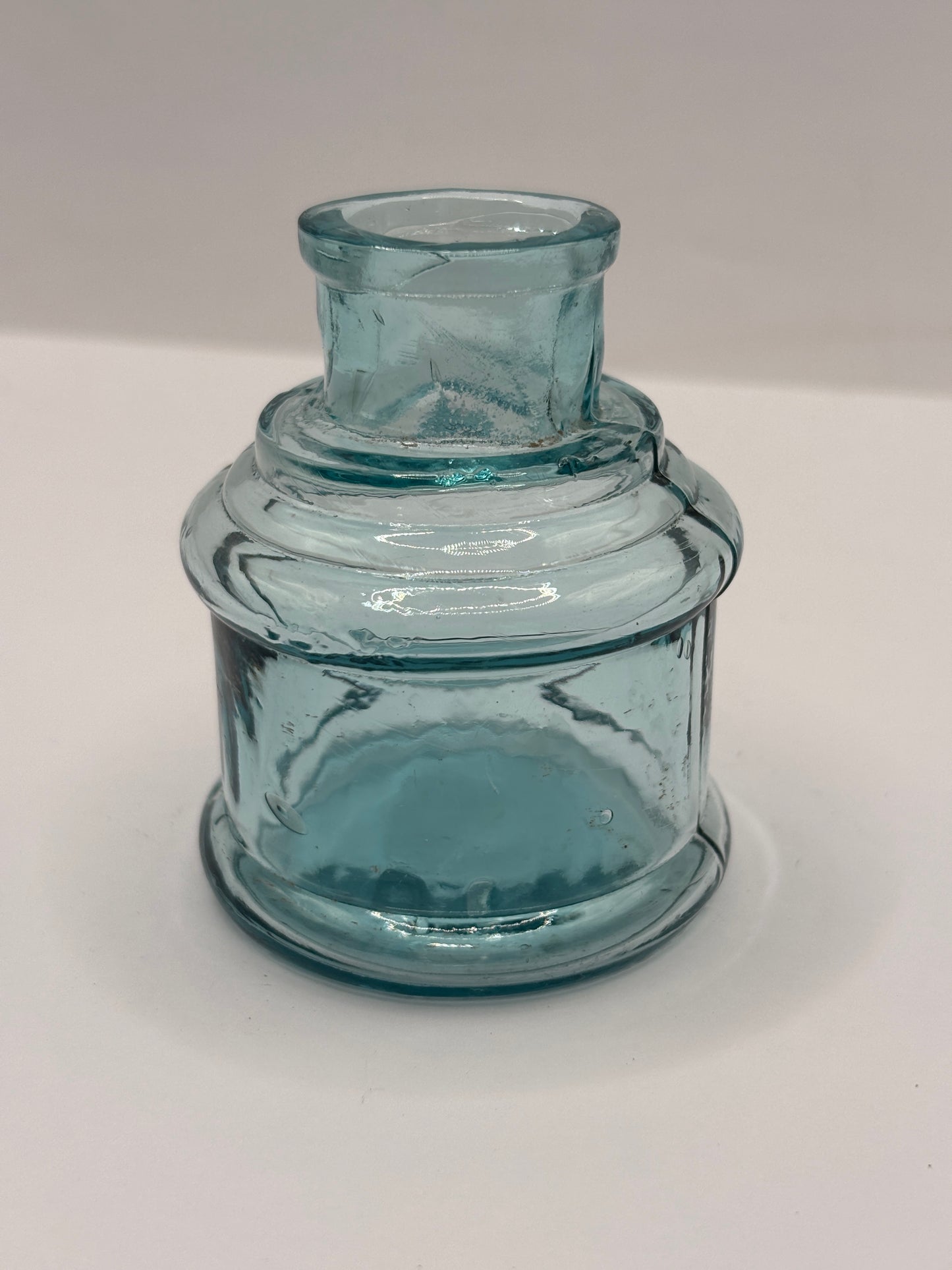 Old light blue glass inkwell, ink bottle