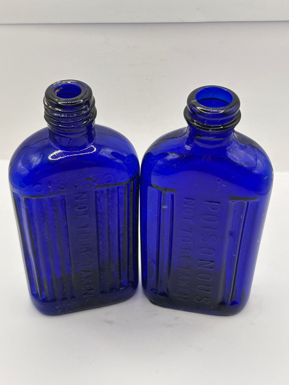 2 old blue glass ribbed poison bottes, not to be taken