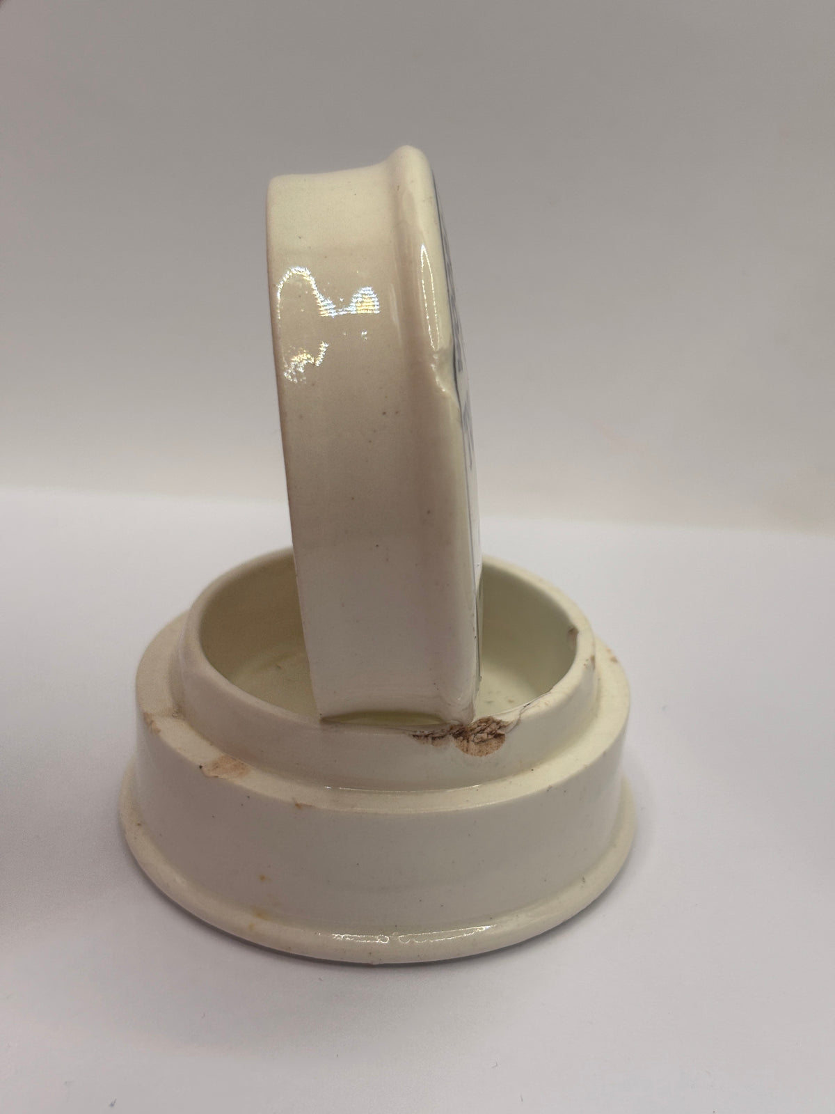 Old advertising lid and base. Woods areca nut tooth paste. Damaged
