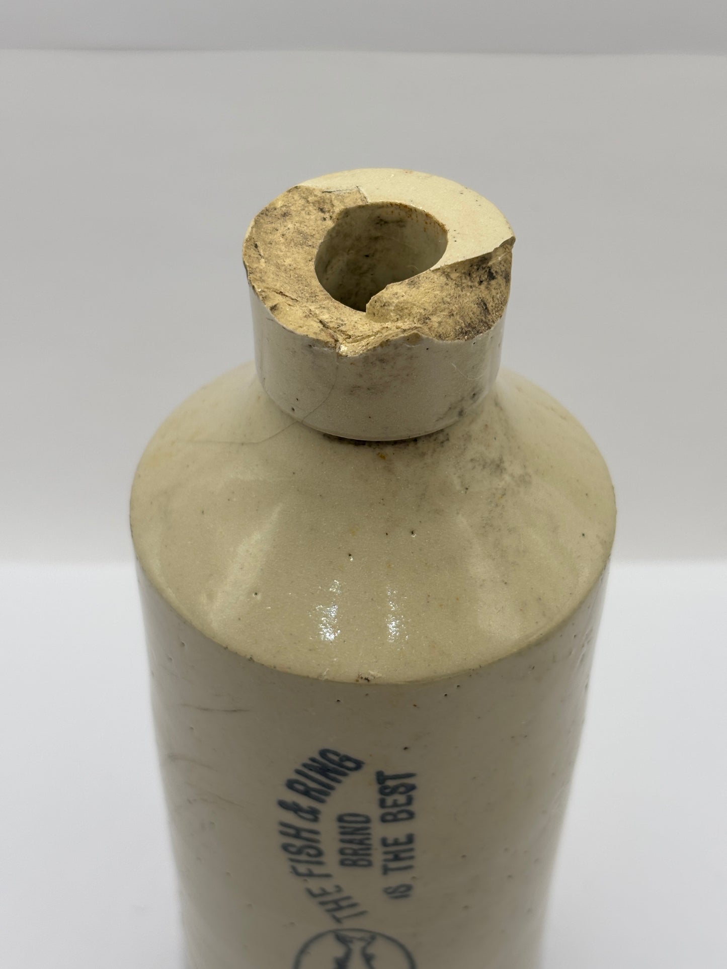 Old stoneware Fish & Ring brand advertising bottle. Damaged