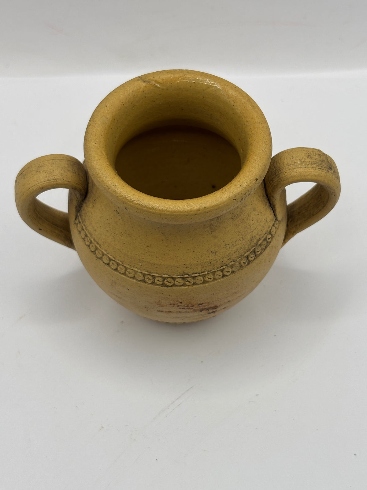 Old stained stoneware handled jug