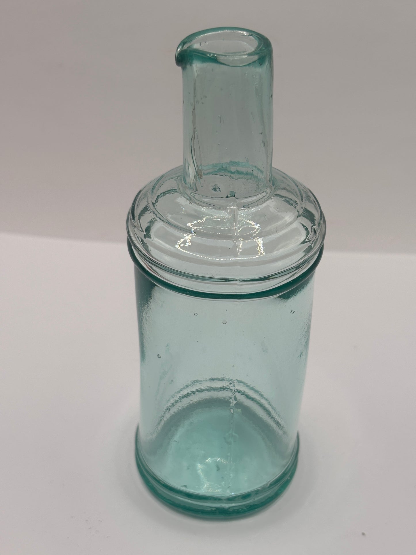 Old tall aqua glass pouring ink, inkwell